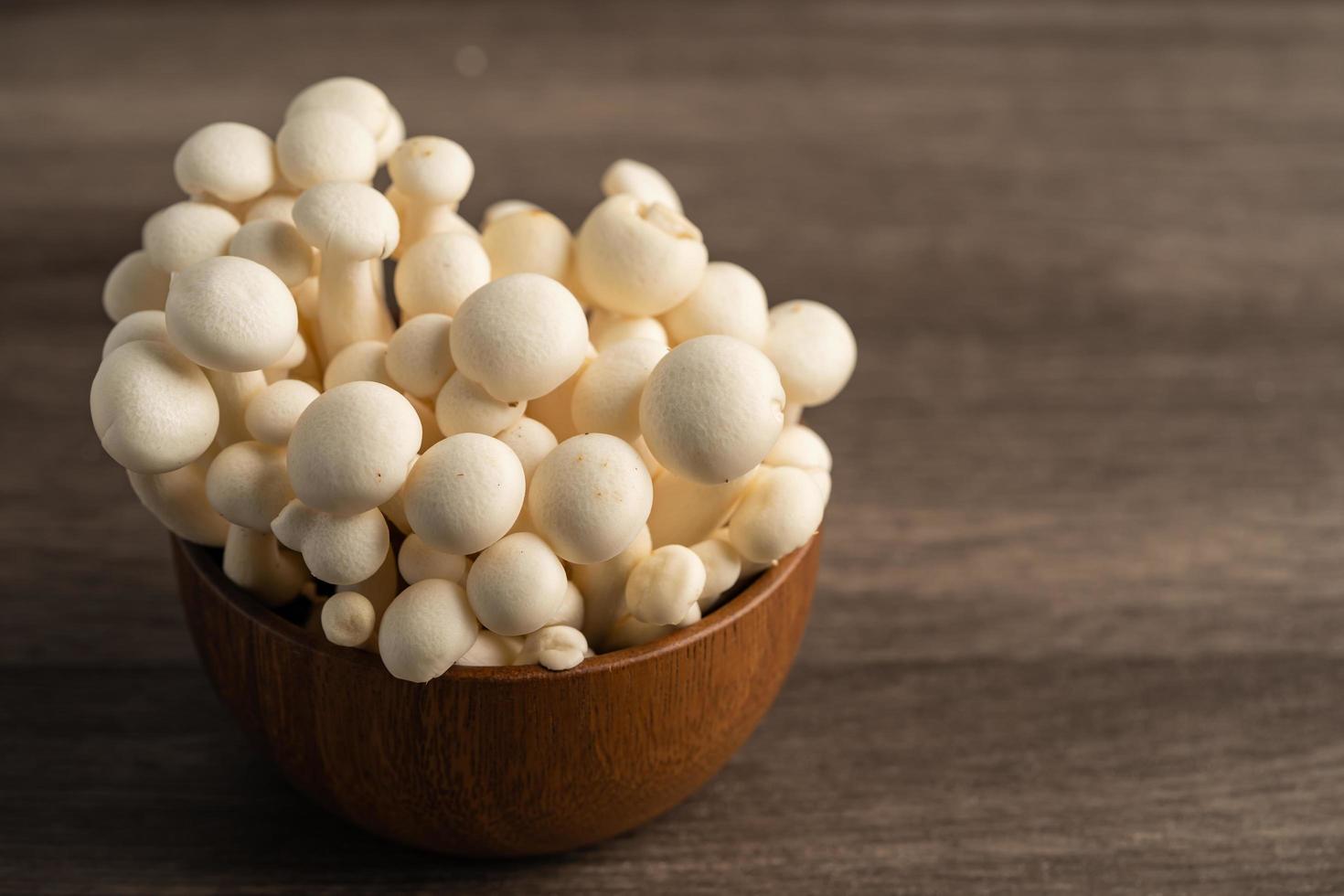 Shimeji, Fresh white bunapi mushrooms from Asia in wooden bowl. photo