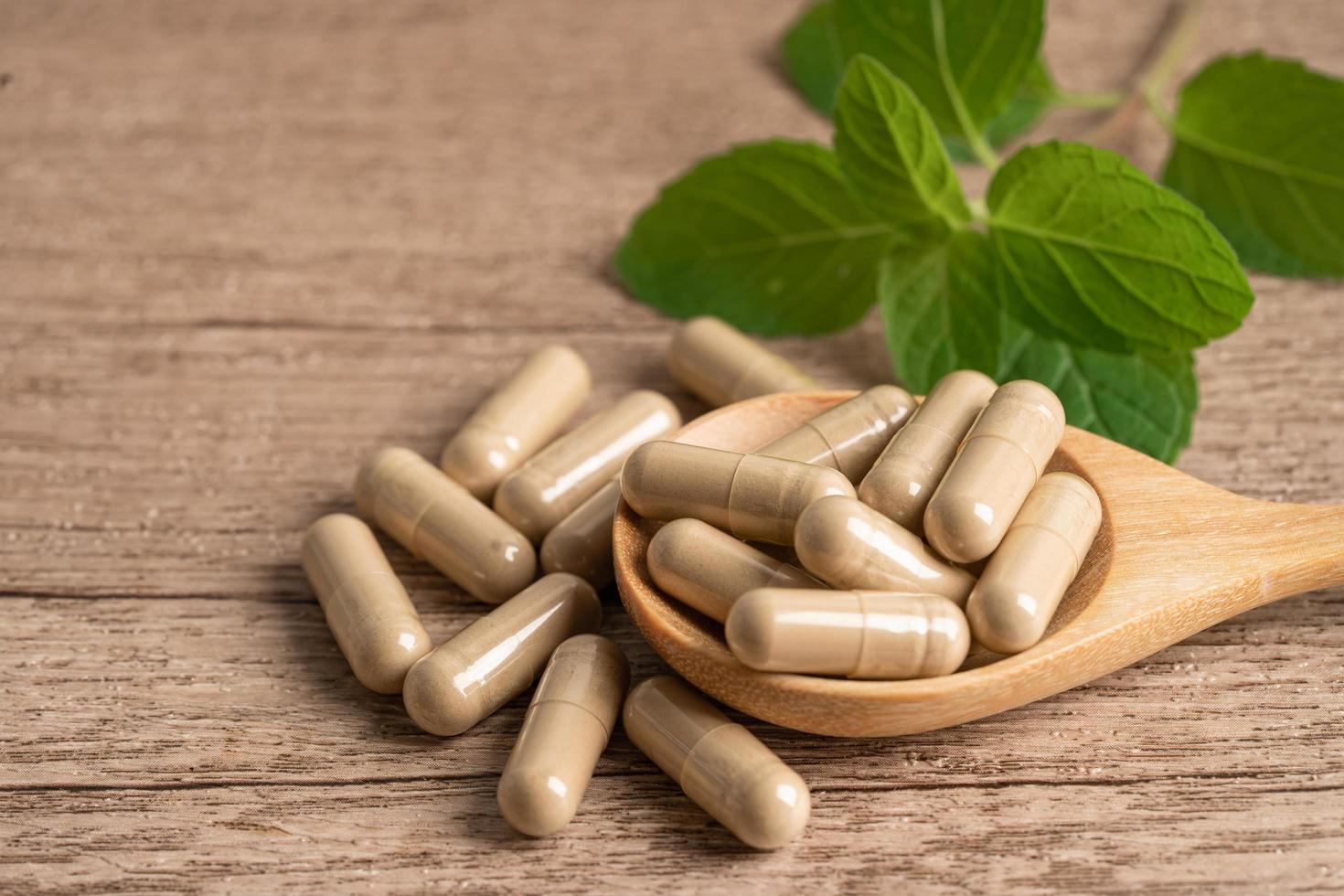 Alternative medicine herbal organic capsule with vitamin E omega 3 fish oil, mineral, drug with herbs leaf natural supplements for healthy good life. photo