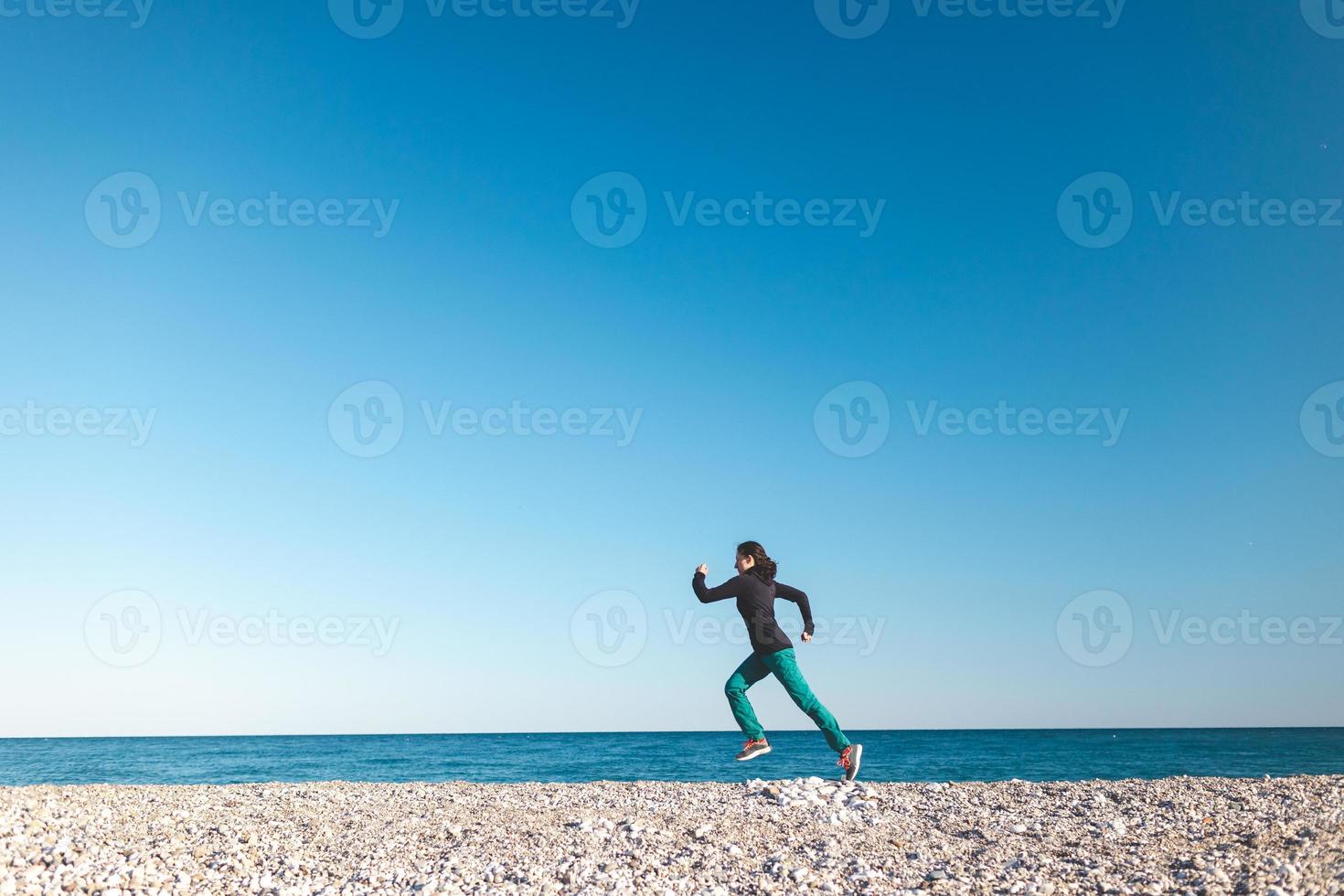 A girl on a morning jog on the beach photo