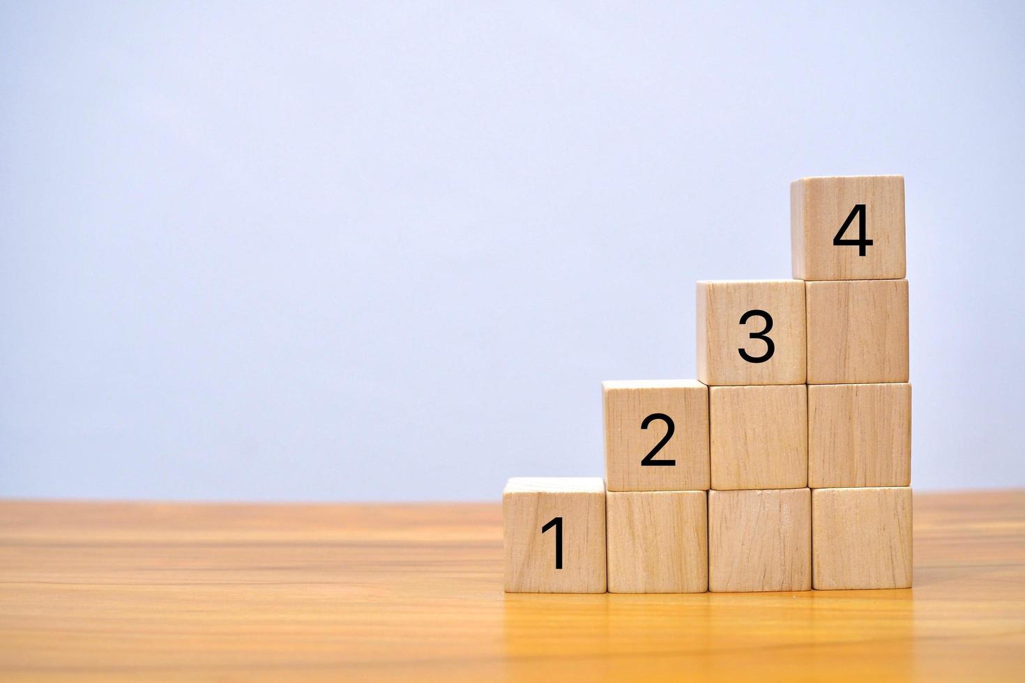 Wooden block number one two three four using as business and education concept. photo