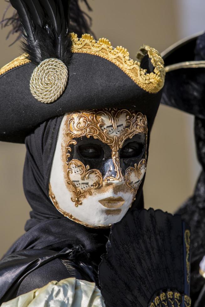 Venice, Italy, 2013 - Unidentified person with Venetian carnival mask in Venice, Italy. At 2013 it is held from January 26th to February 12th. photo