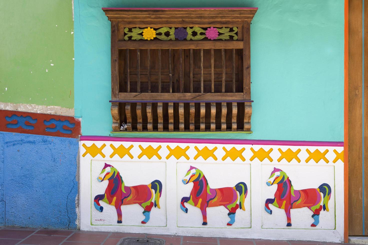 Guatape, Colombia, 2019 - Detail from colorful facade on the building in Guatape, Colombia. Each building in town Guatape has bright color tiles along the lower part of facade. photo