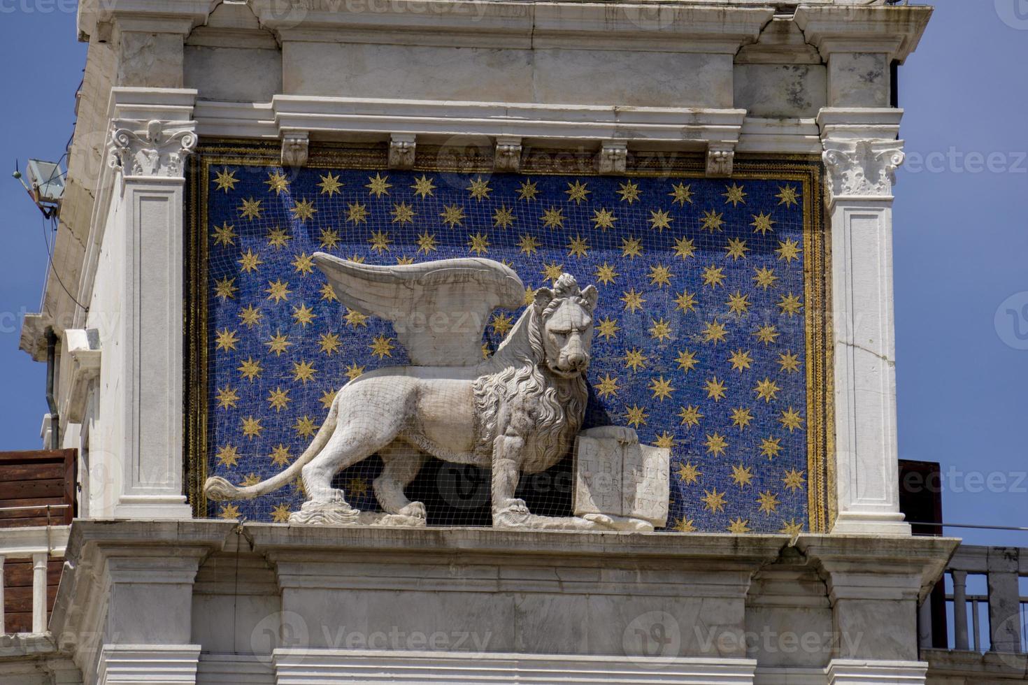 Statue of winged lion on the Clock Tower at Piazza di San Marco in Venice, Italy photo