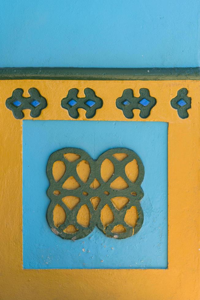 Guatape, Colombia, 2019 - Detail from colorful facade on the building in Guatape, Colombia. Each building in town Guatape has bright color tiles along the lower part of facade. photo