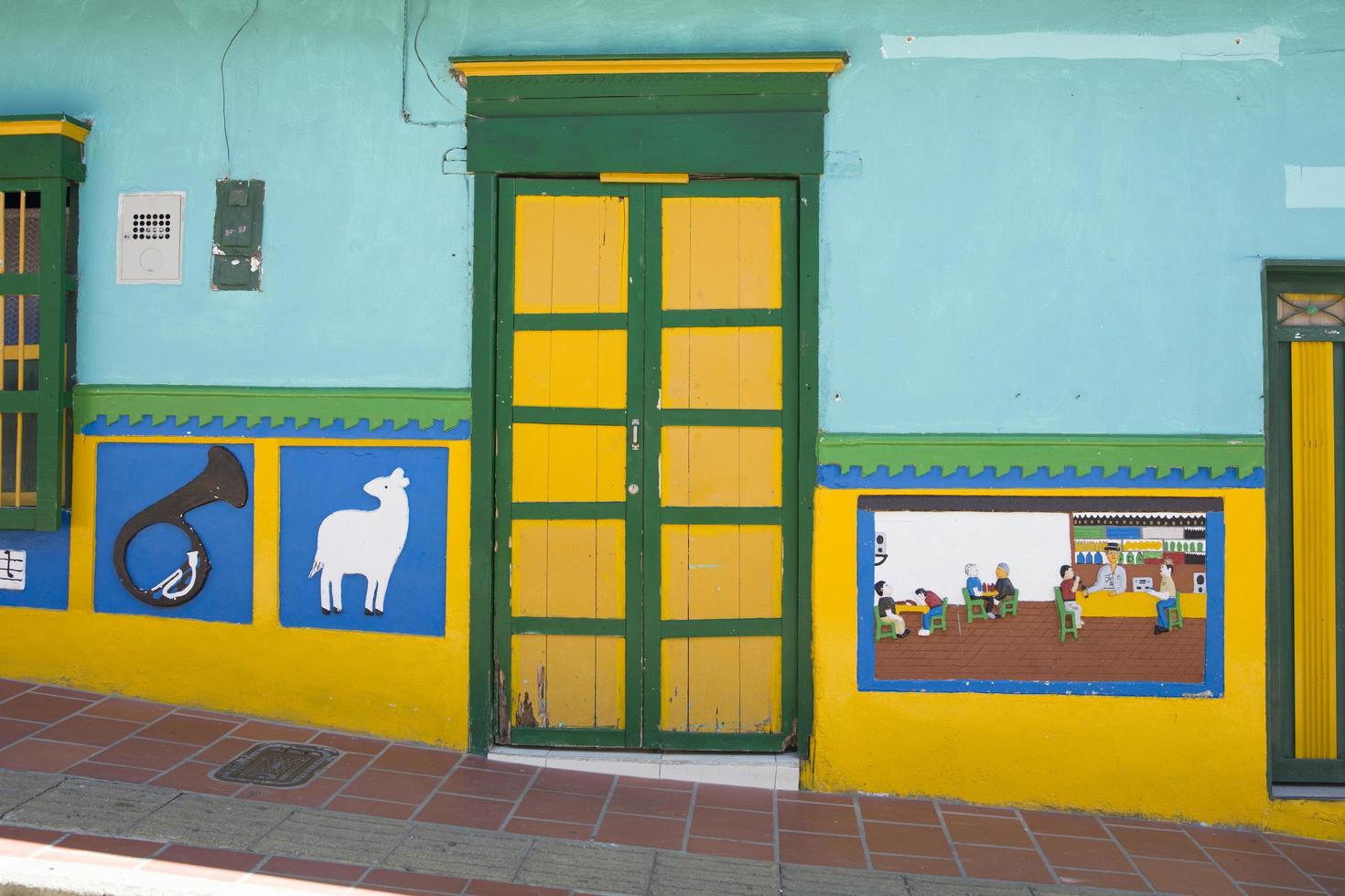Guatape, Colombia, 2019 - Detail from colorful facade on the building in Guatape, Colombia. Each building in town Guatape has bright color tiles along the lower part of facade. photo