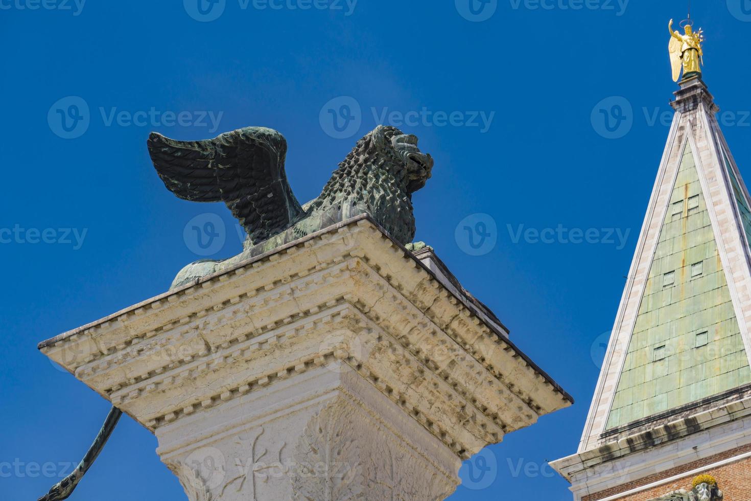 Sculpture depicting image of lion with wings, symbol of Venice, on the top of the column at San Marco, Italy photo