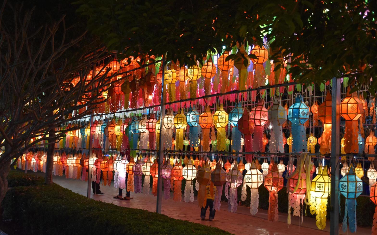 Beautifully shaped and colorful paper lanterns are hung in front of a pagoda to worship Lord Buddha in a temple in northern Thailand. photo