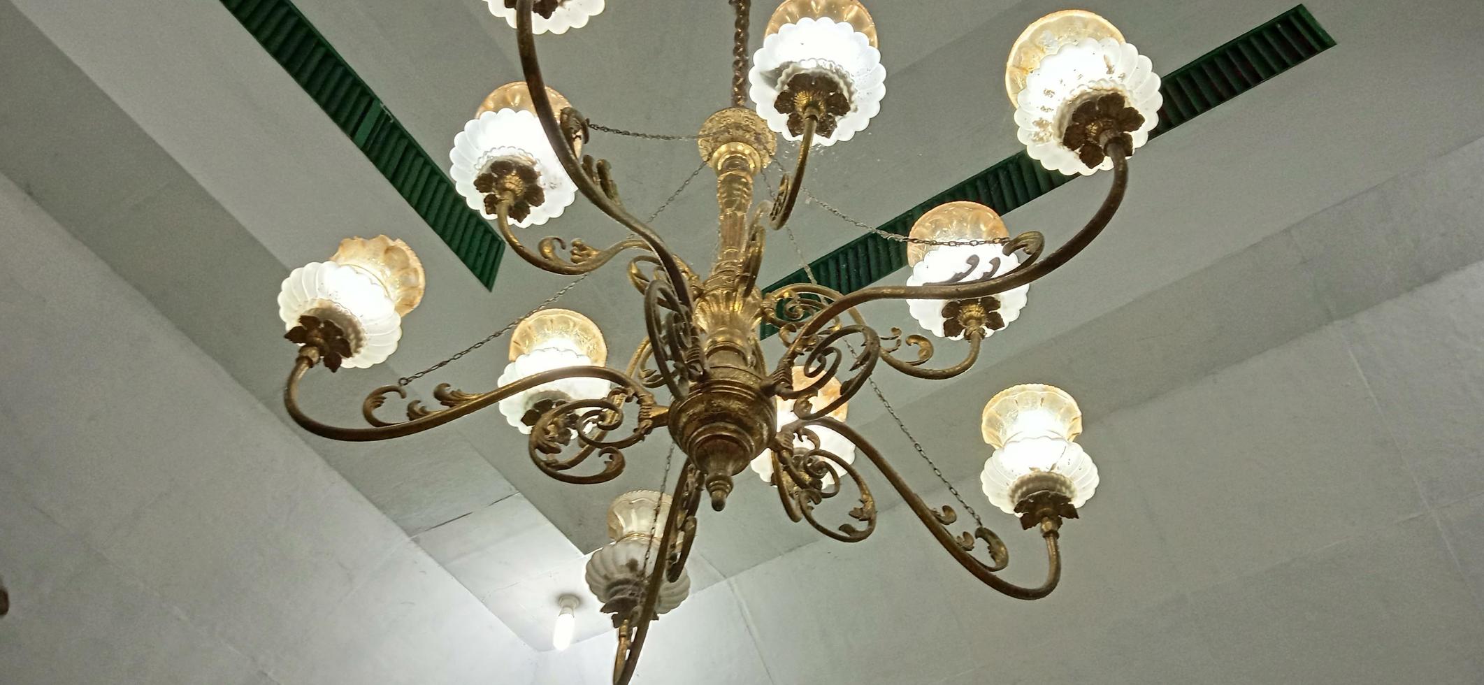 An old-golden traditional chandelier in the old mosque at Cirebon West Java Indonesia. photo