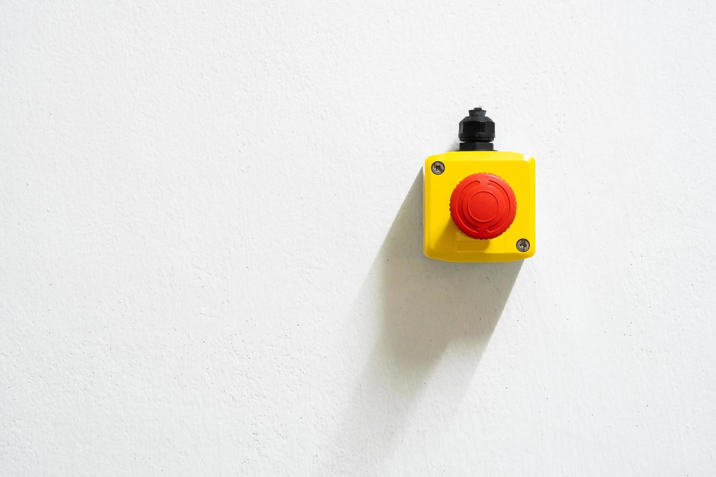 Stop Red Button and the Hand of Worker About to Press it. emergency stop button. Big Red emergency button or stop button for manual pressing. photo