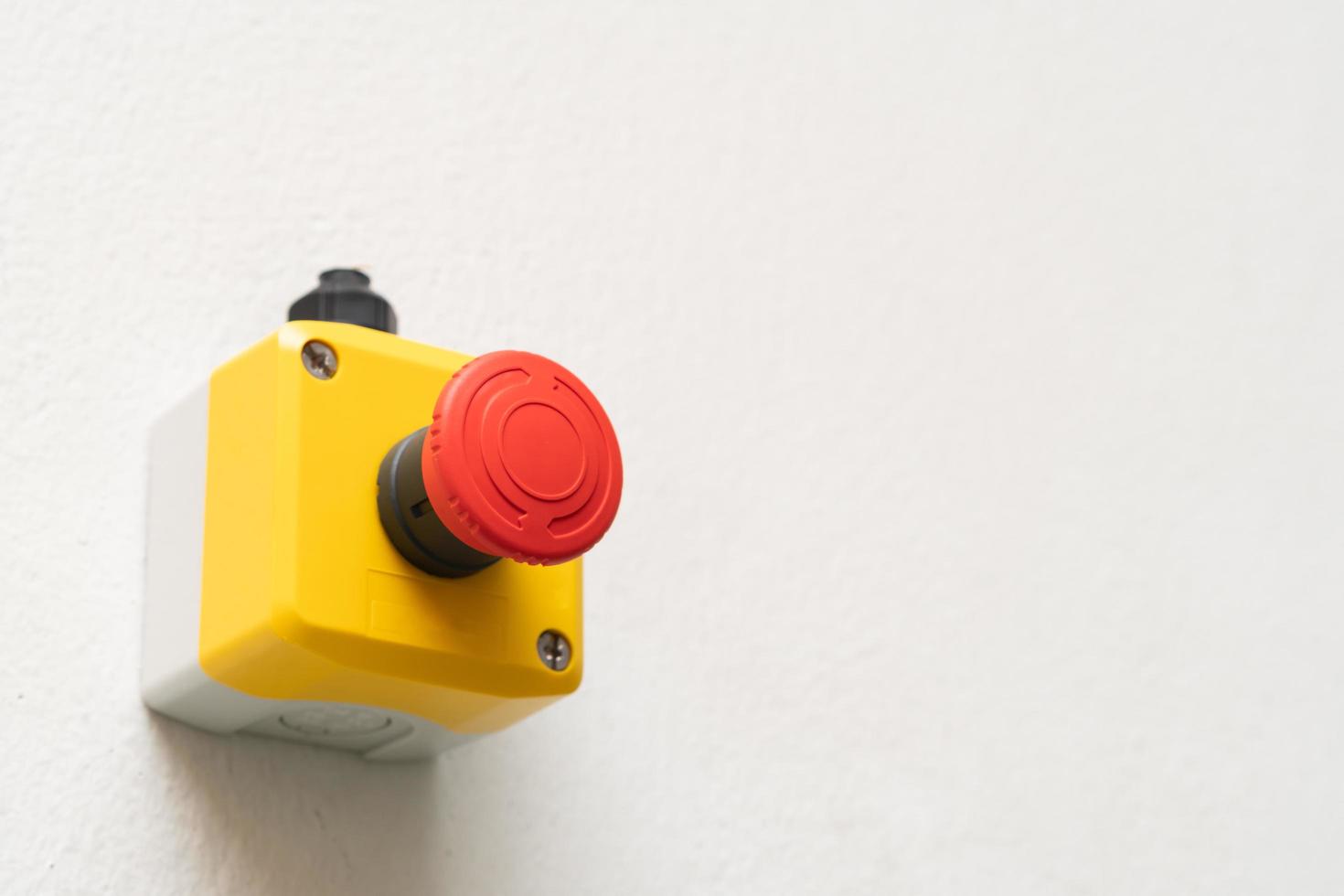 Stop Red Button and the Hand of Worker About to Press it. emergency stop button. Big Red emergency button or stop button for manual pressing. photo