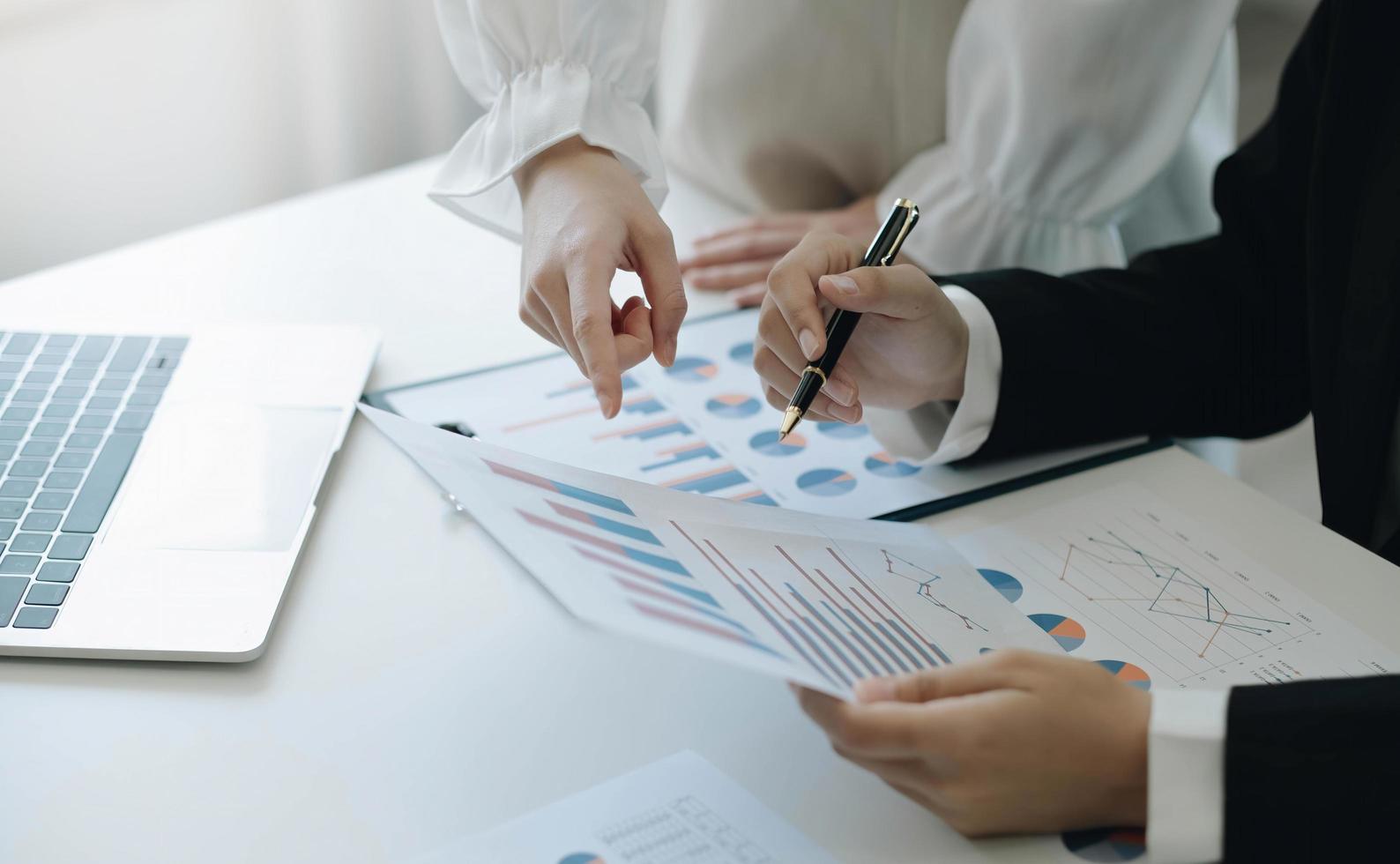 Business team analyzing income charts and graphs with modern laptop computer. Close up.Business analysis and strategy concept. photo