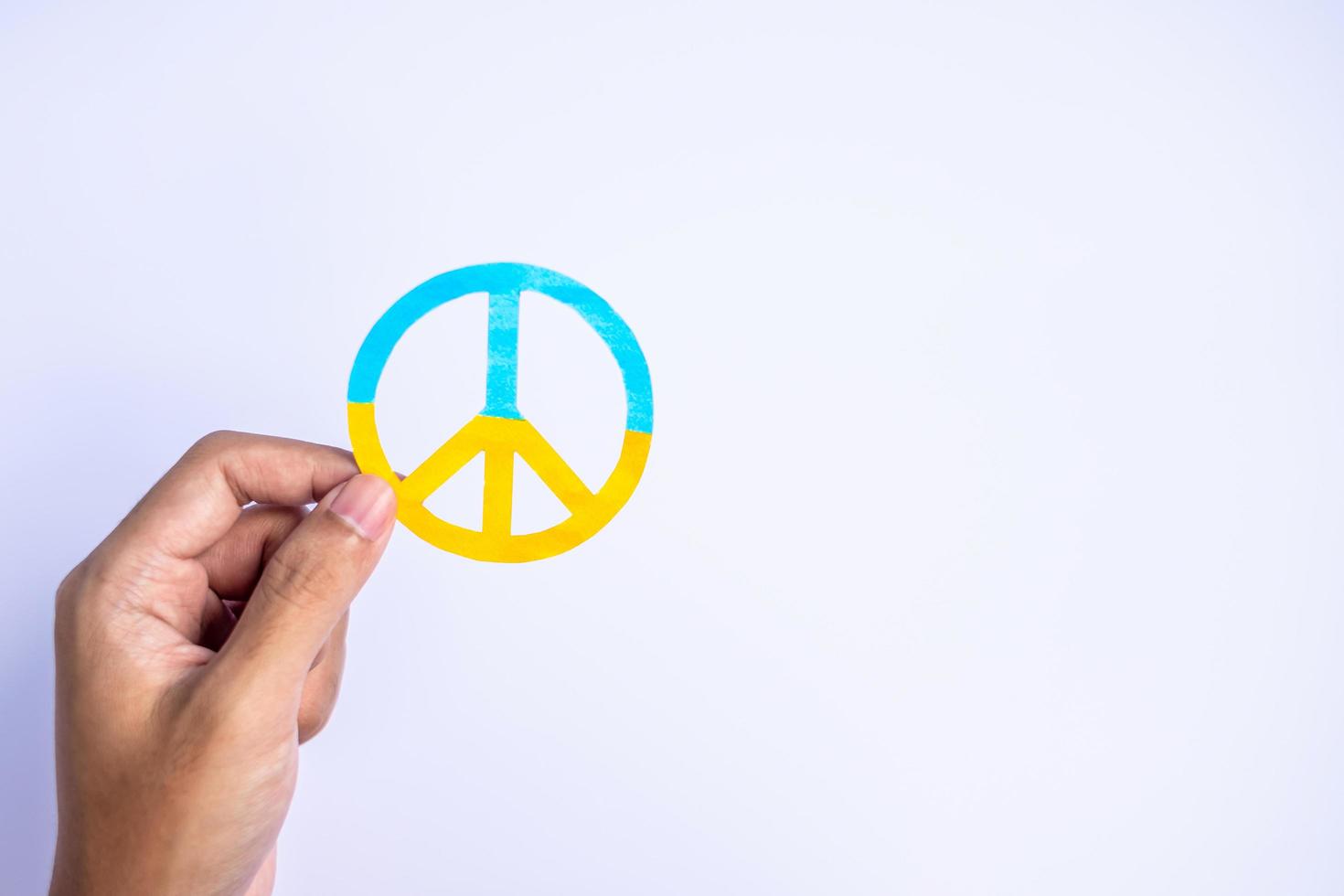 Support for Ukraine in the war with Russia, Hands holding symbol of peace with flag of Ukraine. Pray, No war, stop war, stand with Ukraine and Nuclear Disarmament photo