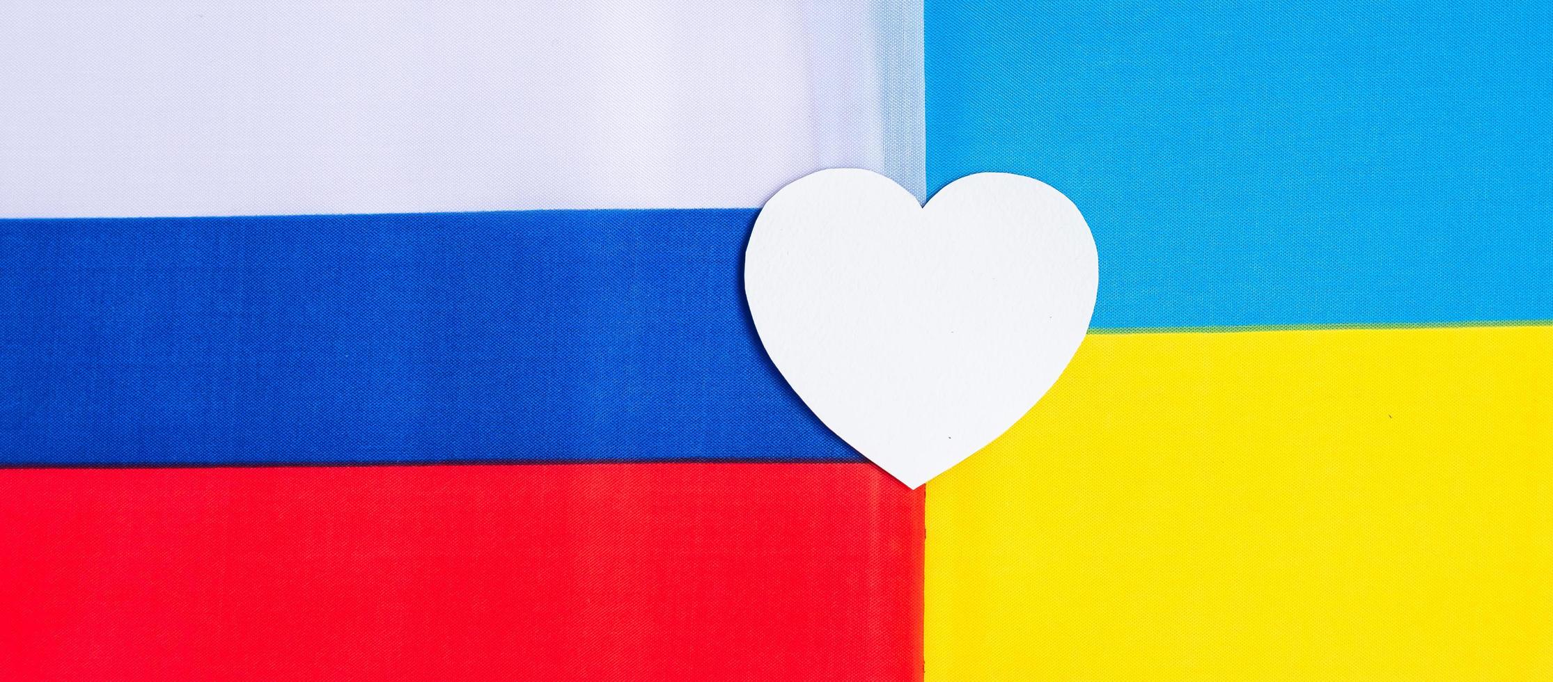 symbol of heart with flag of Ukraine. and Russia Pray, No war, stop war and love concept photo