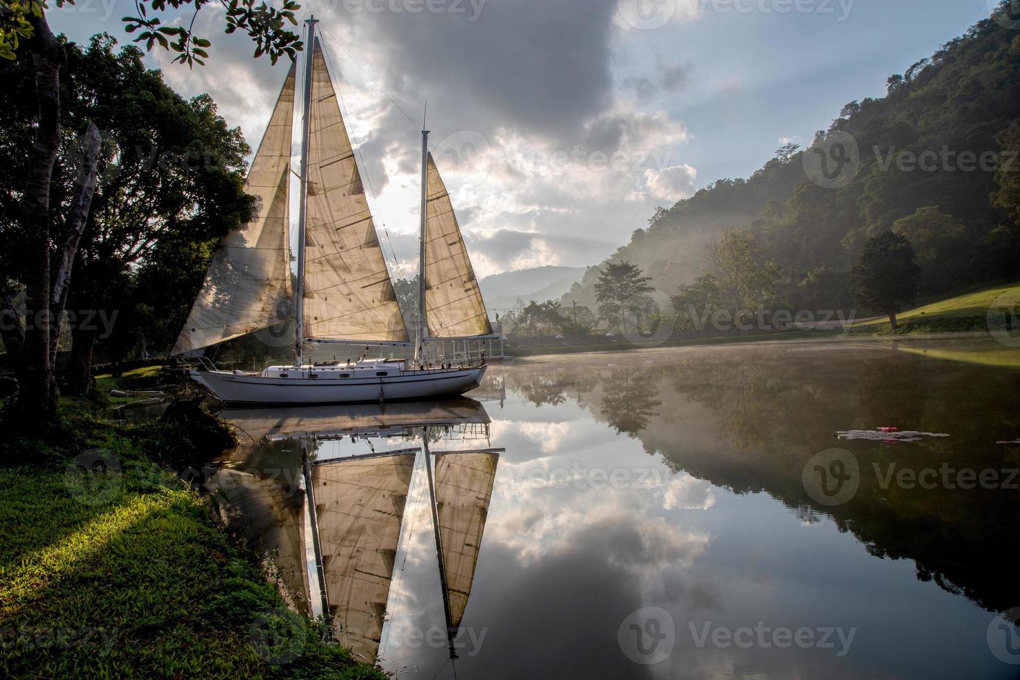 A sailboat in lake with morning light. photo