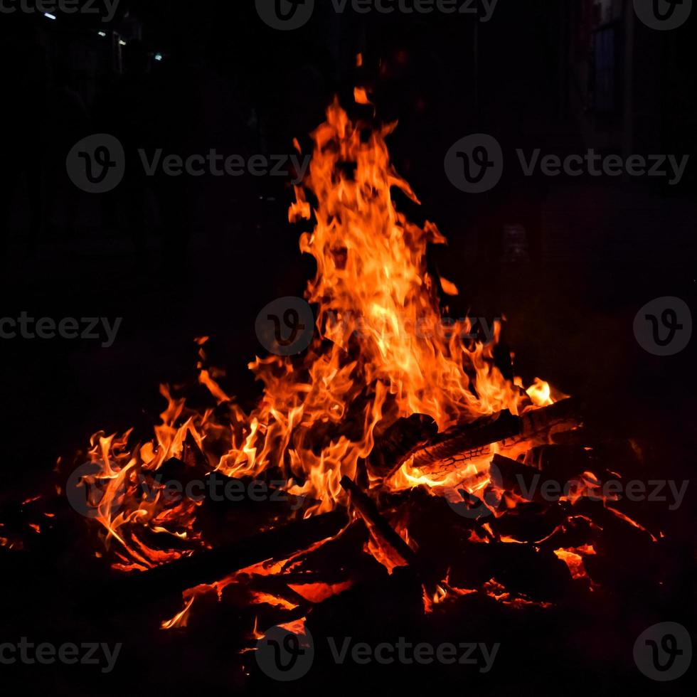 Fire flames on black background, Blaze fire flame texture background, Beautifully, the fire is burning, Fire flames with wood and cow dung photo