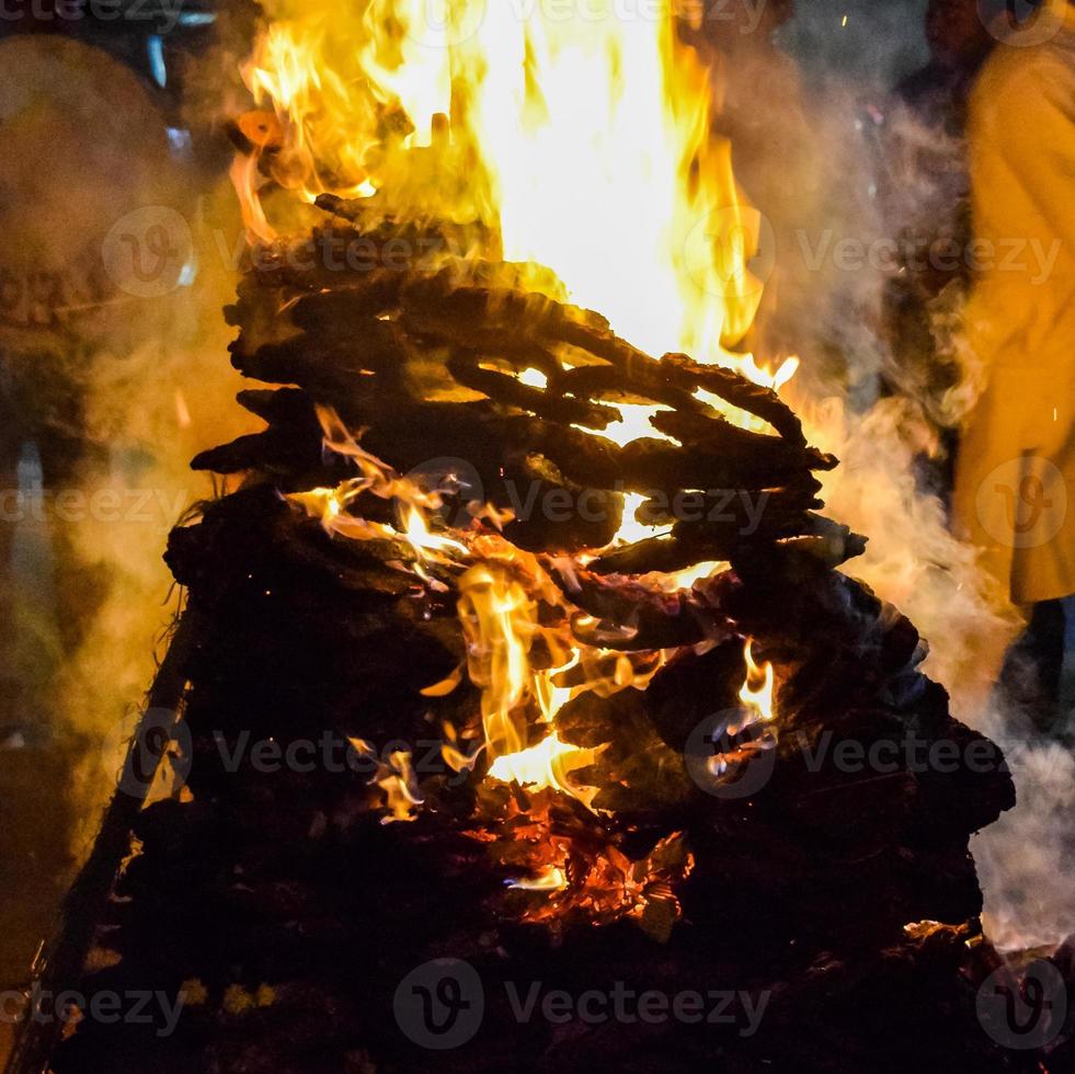 Fire flames on black background, Blaze fire flame texture background, Beautifully, the fire is burning, Fire flames with wood and cow dung photo