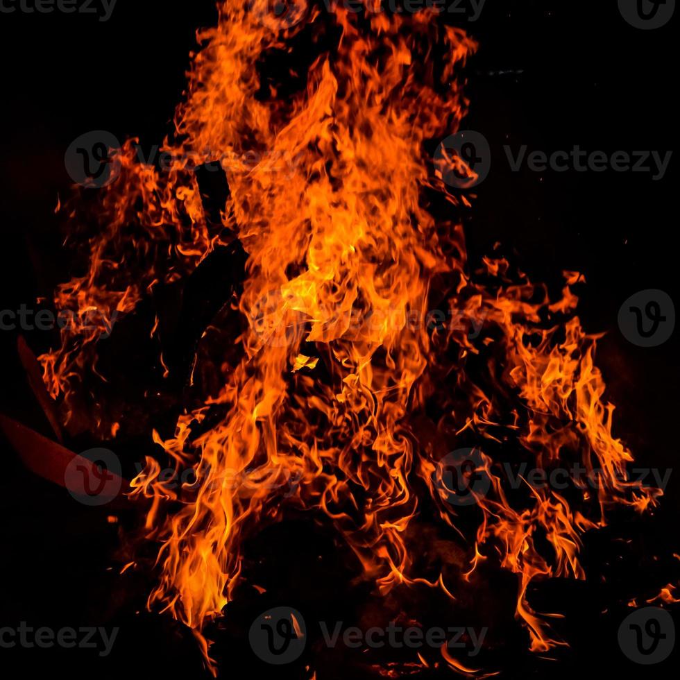 Fire flames on black background, Blaze fire flame texture background, Beautifully, the fire is burning, Fire flames with wood and cow dung photo