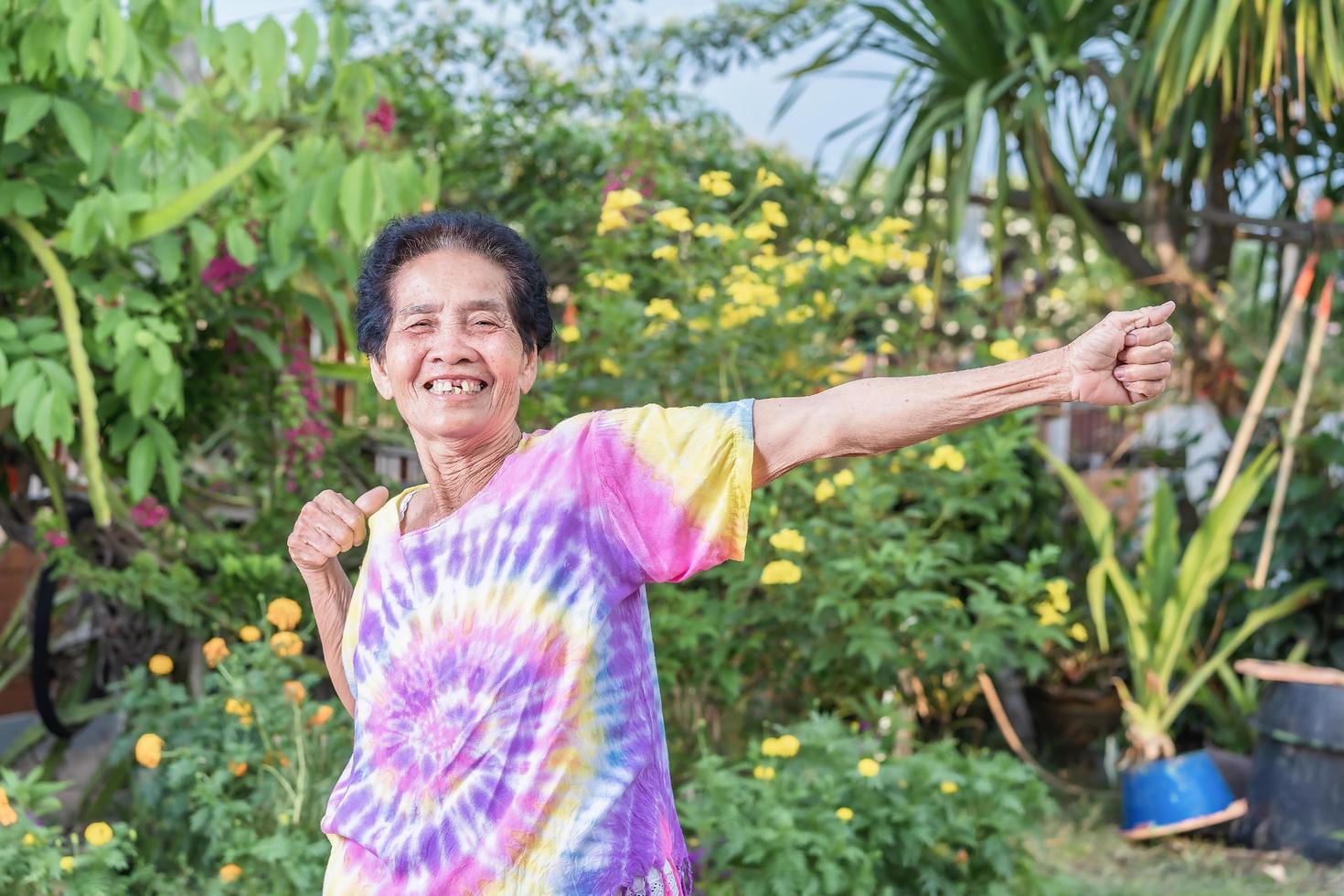 Old Asian woman face with wrinkle elderly senior smiling happiness with a few broken teeth. photo