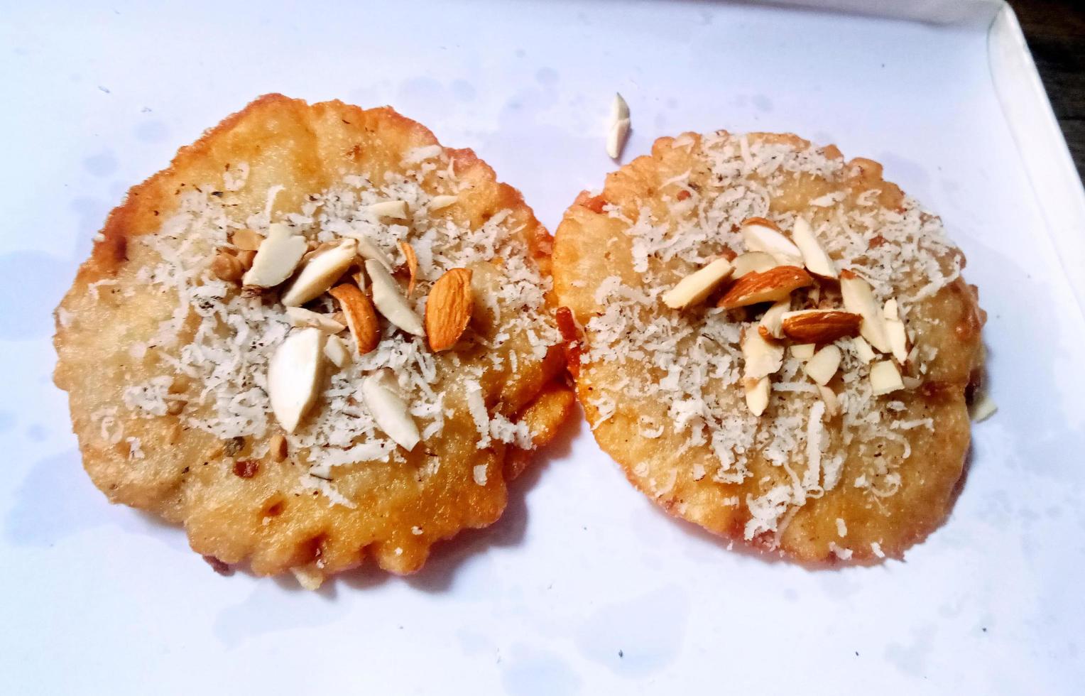 Malpua - Traditional Indian sweet pancake coated in sugar syrup made during Holi and Eid,top down view photo