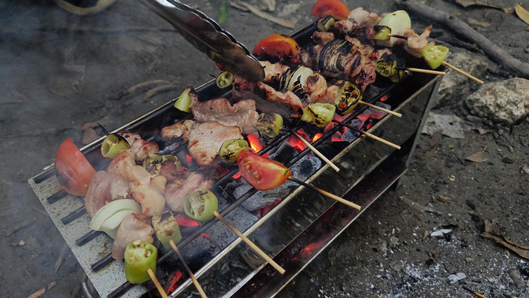 Barbecue skewers meat chicken and pork with vegetables on flaming grill photo