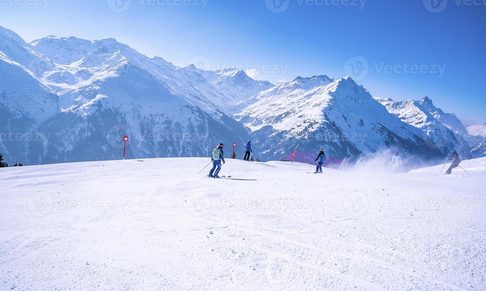 Skiers sliding down snowy slope on mountain at winter resort 11973079 Stock  Photo at Vecteezy