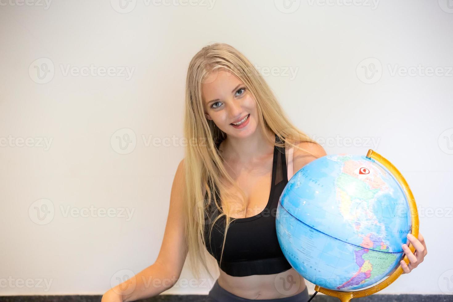 Portrait Of Young Woman holding global map. photo
