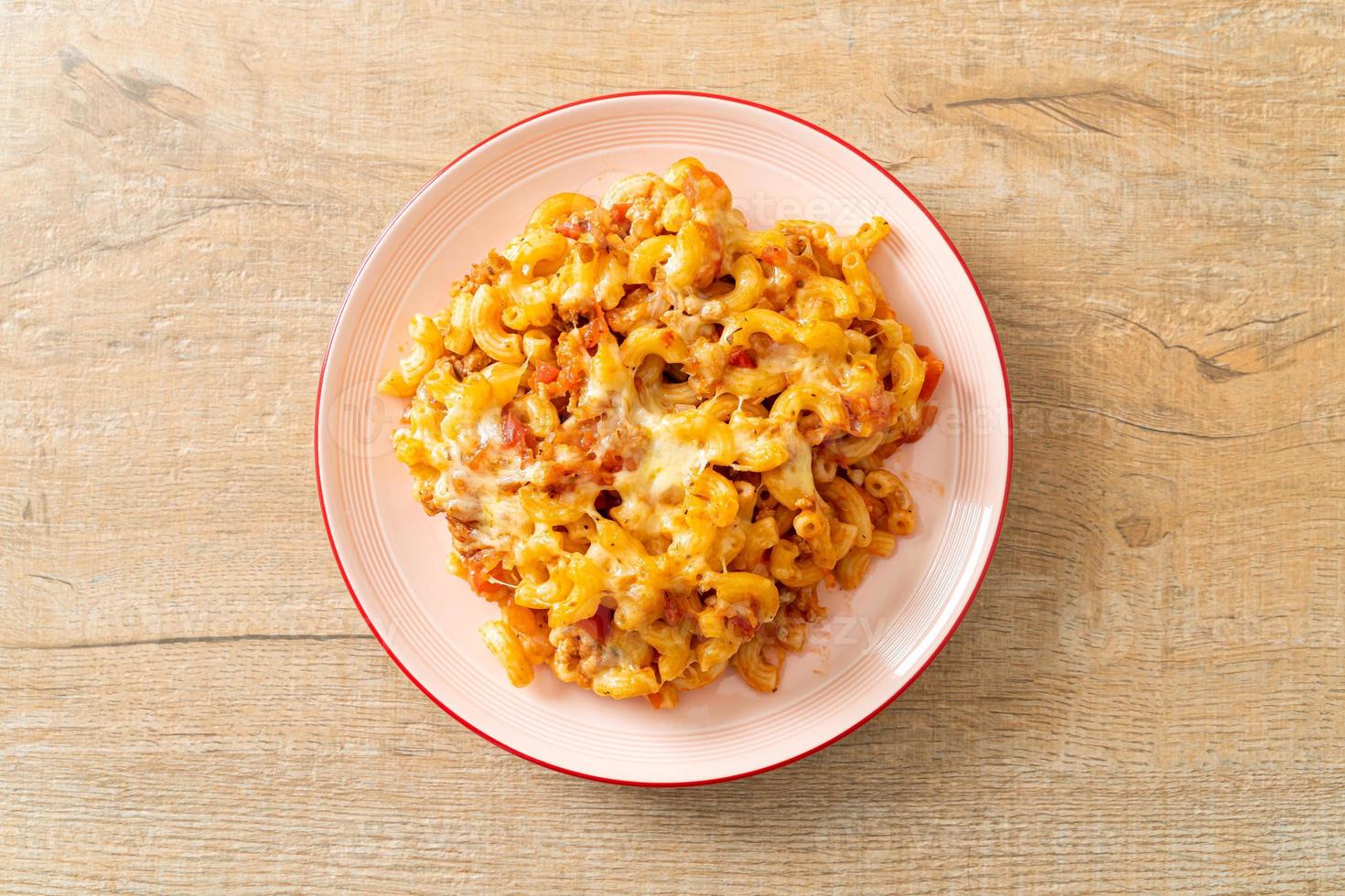 homemade macaroni bolognese with cheese photo