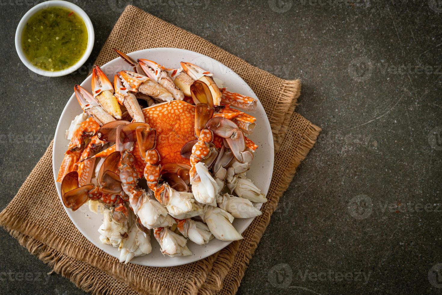 Steamed blue crab with spicy seafood sauce photo