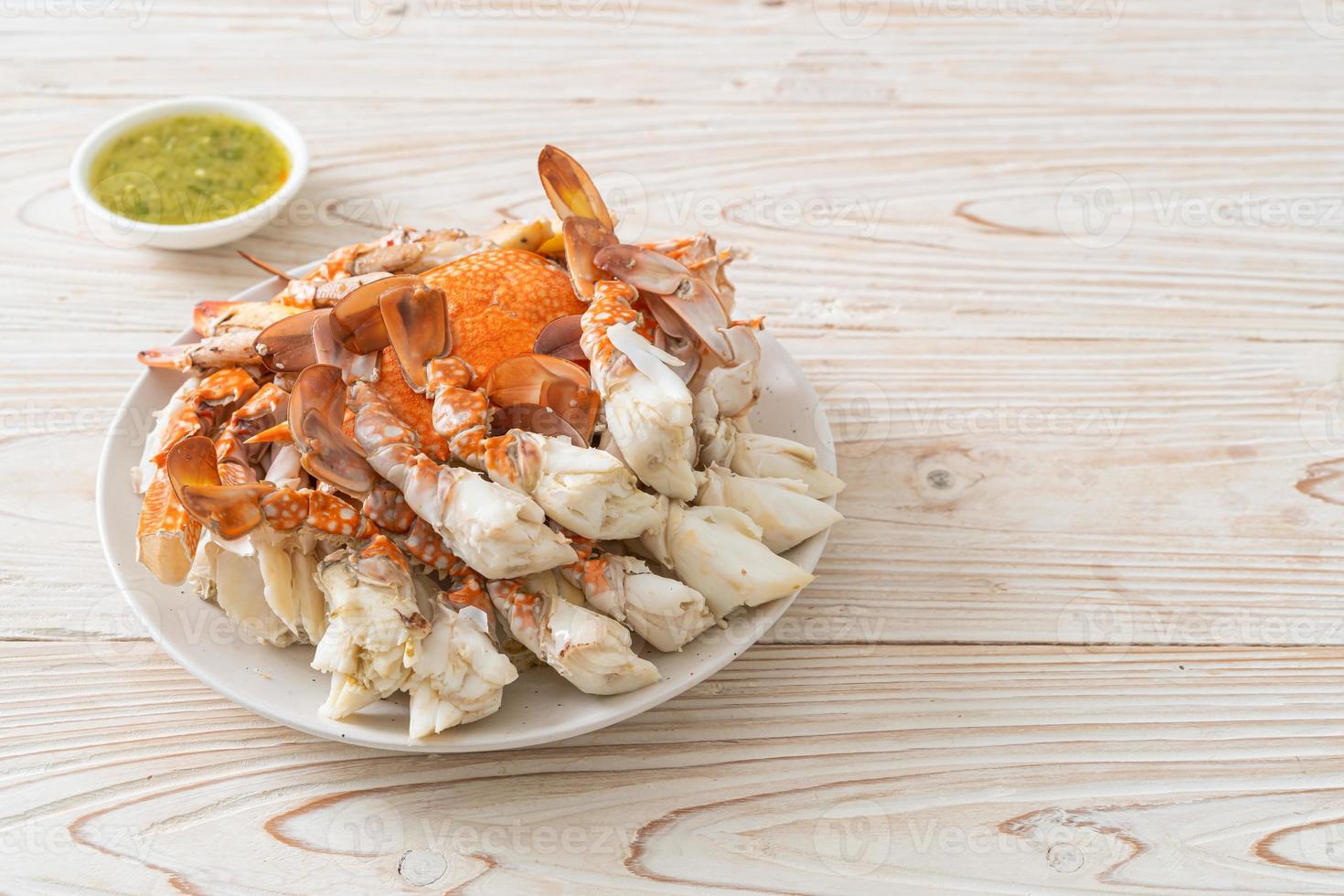Steamed blue crab with spicy seafood sauce photo