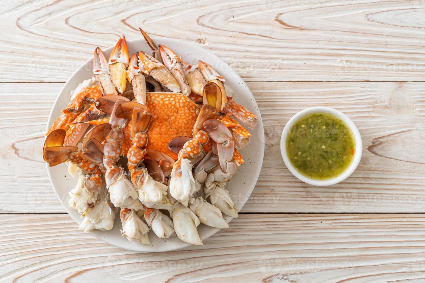 Steamed blue crab with spicy seafood sauce photo