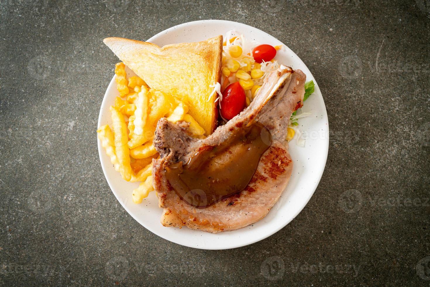pork chop steak with chips and mini salad photo