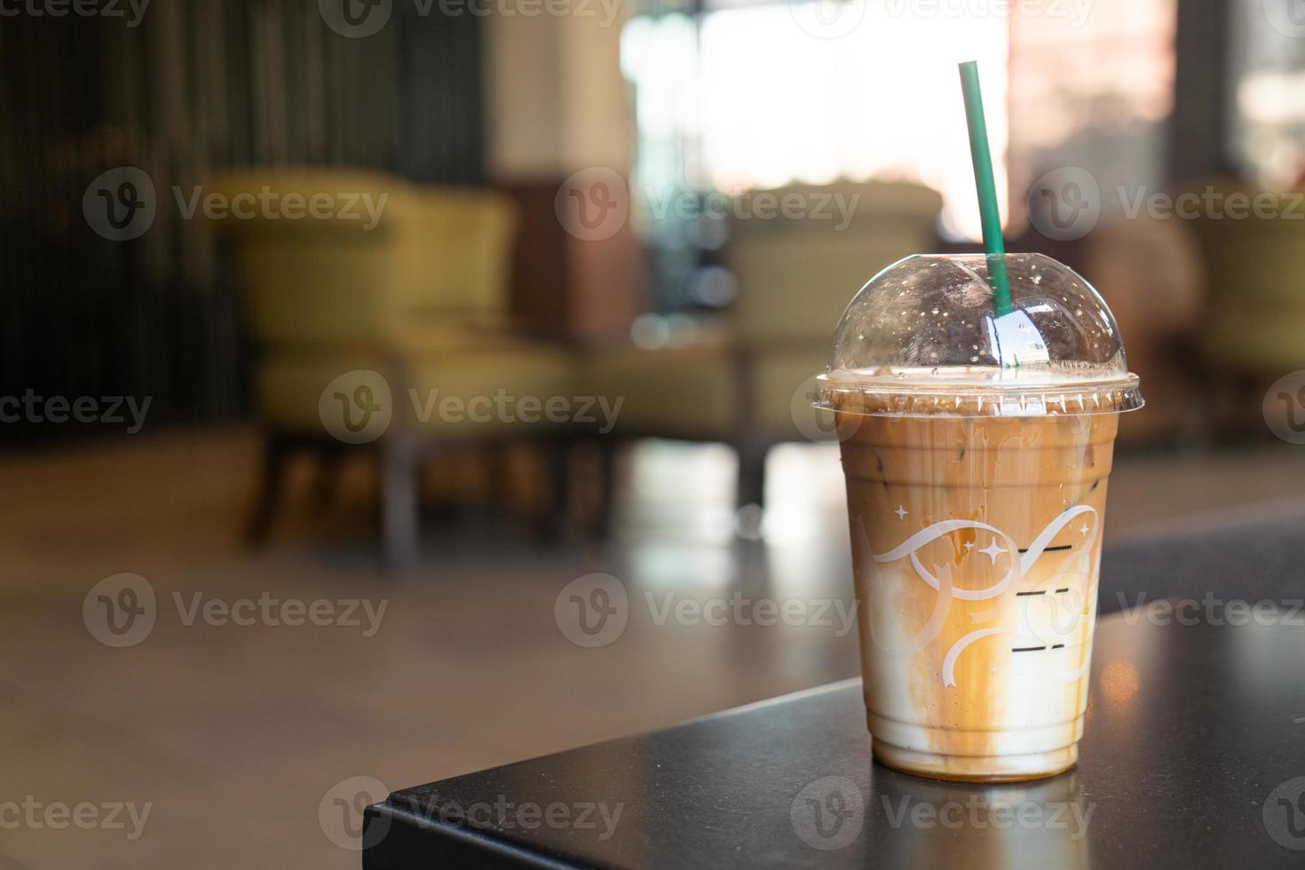 caramel macchiato coffee cup in coffee shop photo