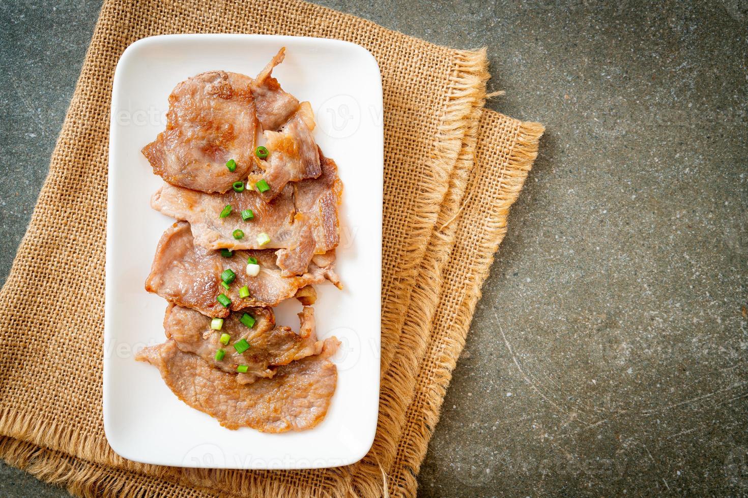 grilled pork neck sliced on plate photo