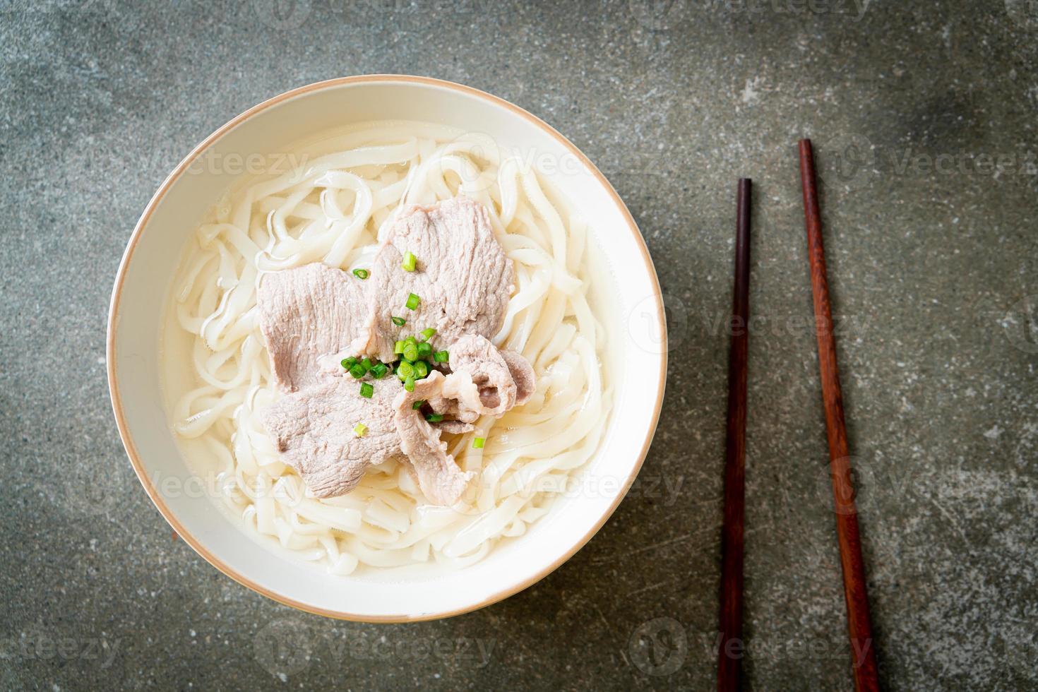 udon noodles with pork in clear soup photo