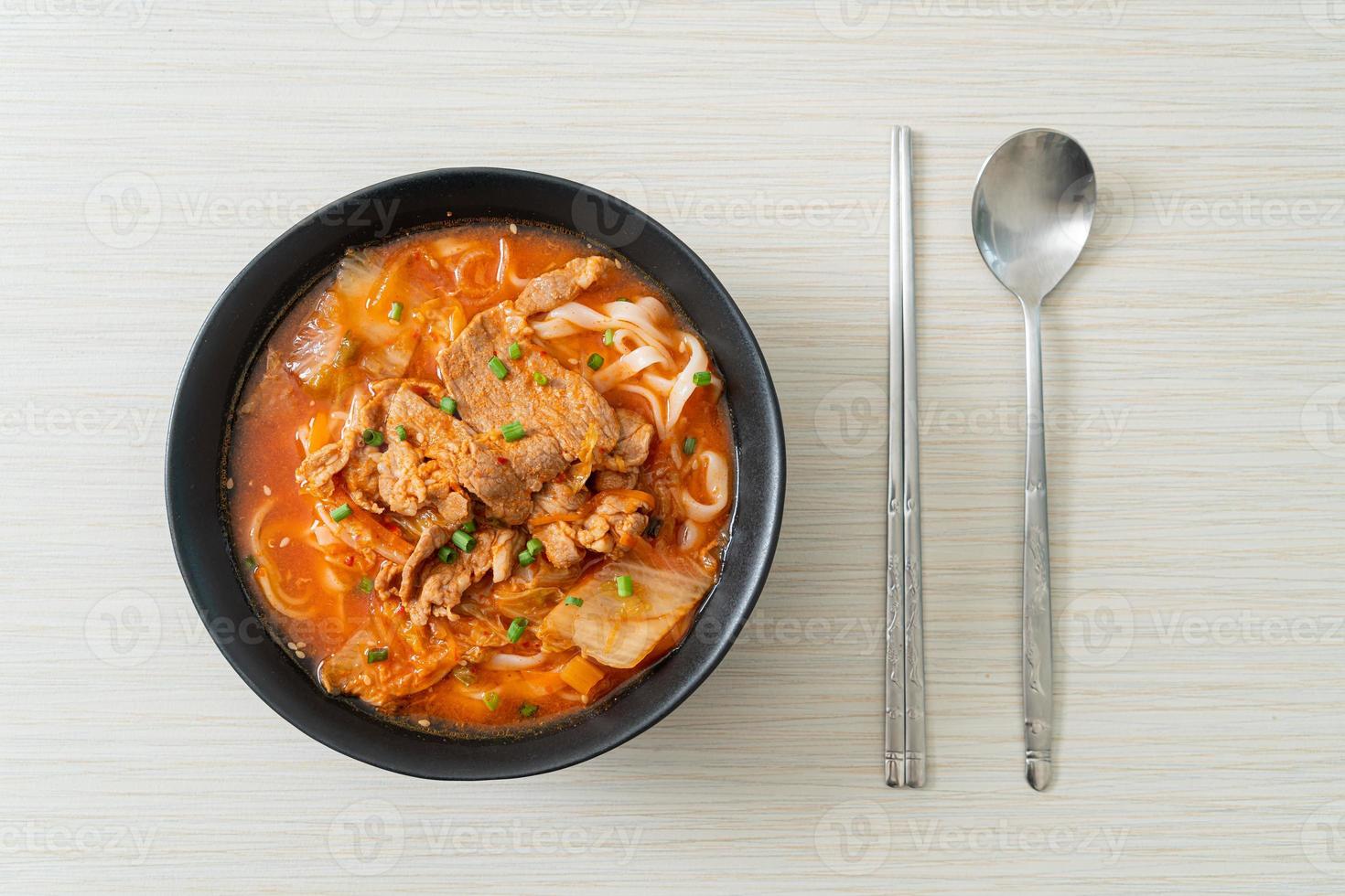 Korean udon ramen noodles with pork in kimchi soup photo