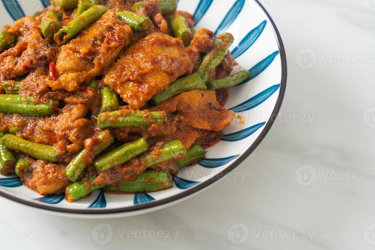 Stir fried pork with red curry paste photo