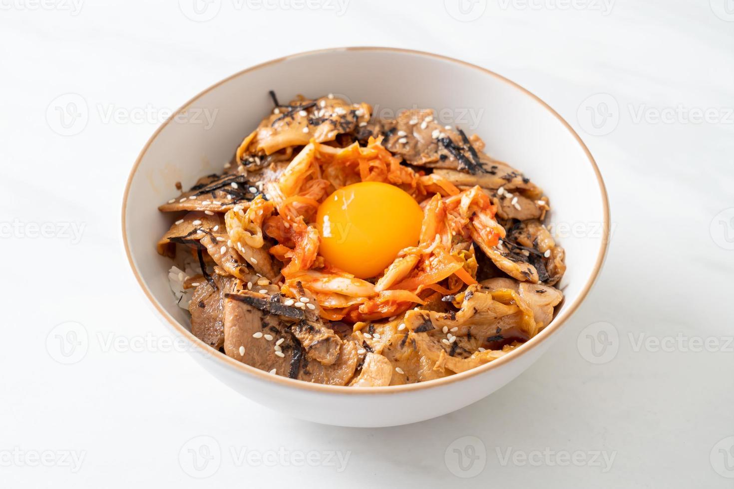 pork bulgogi rice bowl with kimchi and Korean pickled egg photo