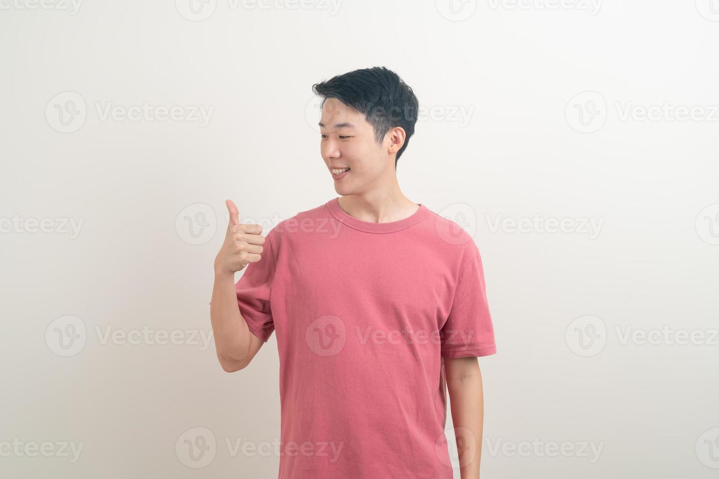 young Asian man thumbs up or ok hand sign photo