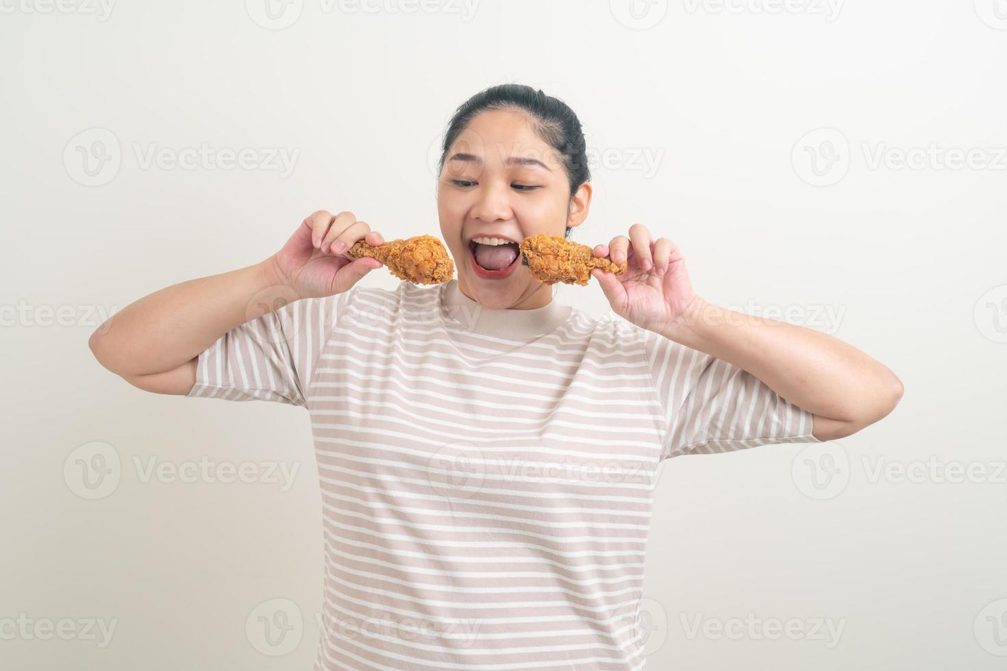 Asian woman with fried chicken on hand photo