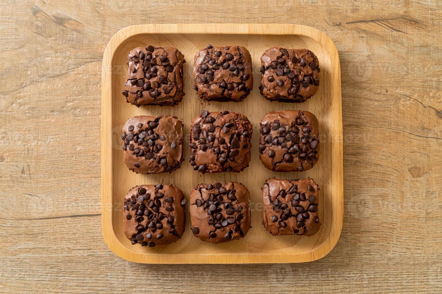 dark chocolate brownies topped by chocolate chips photo