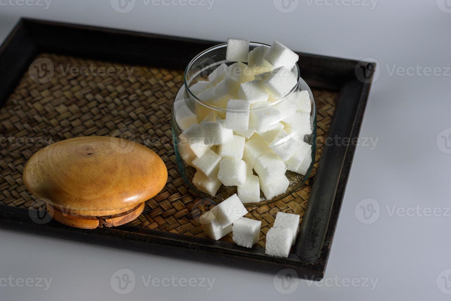Sugar in a dozen openings on the tray. photo