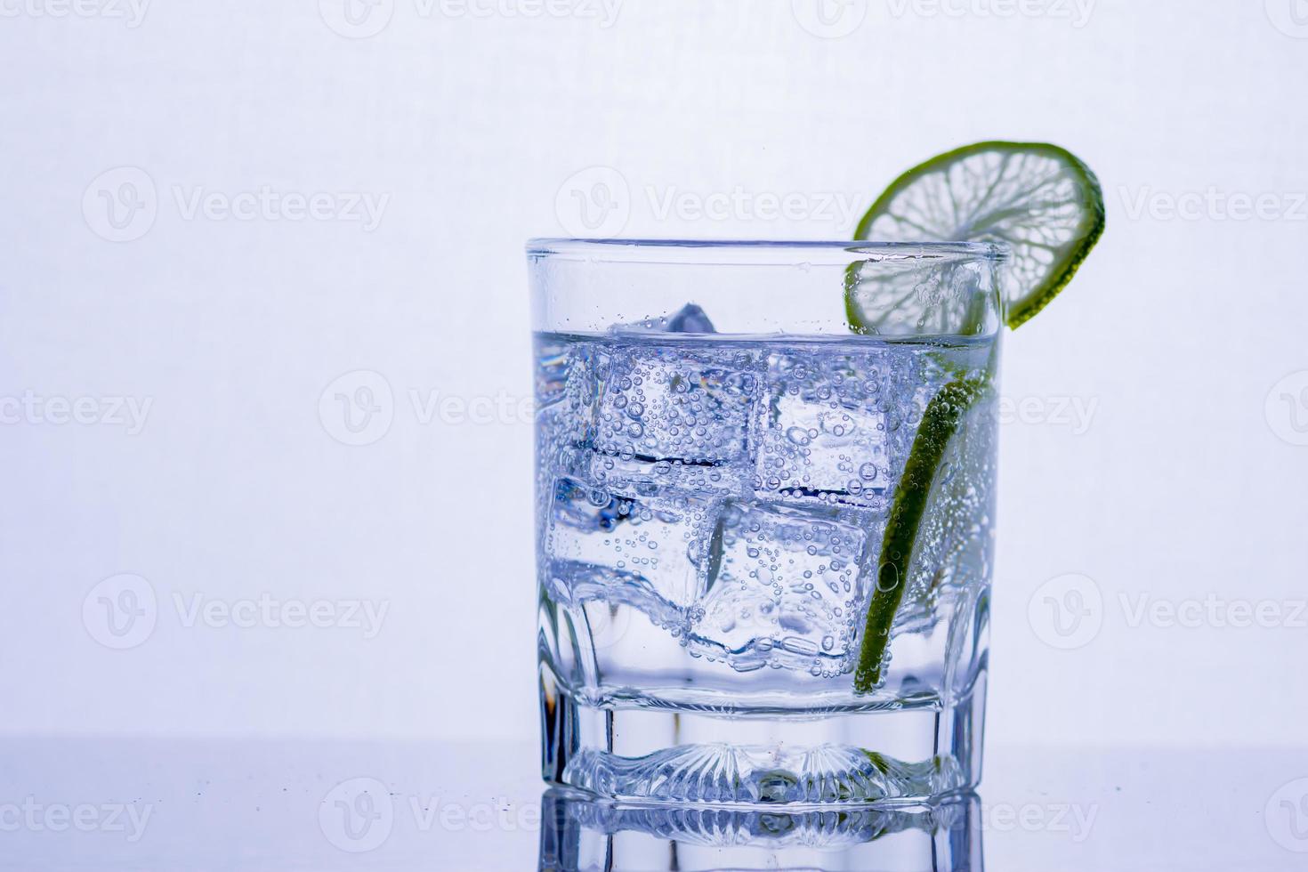 Glass of whiskey on a glass table photo