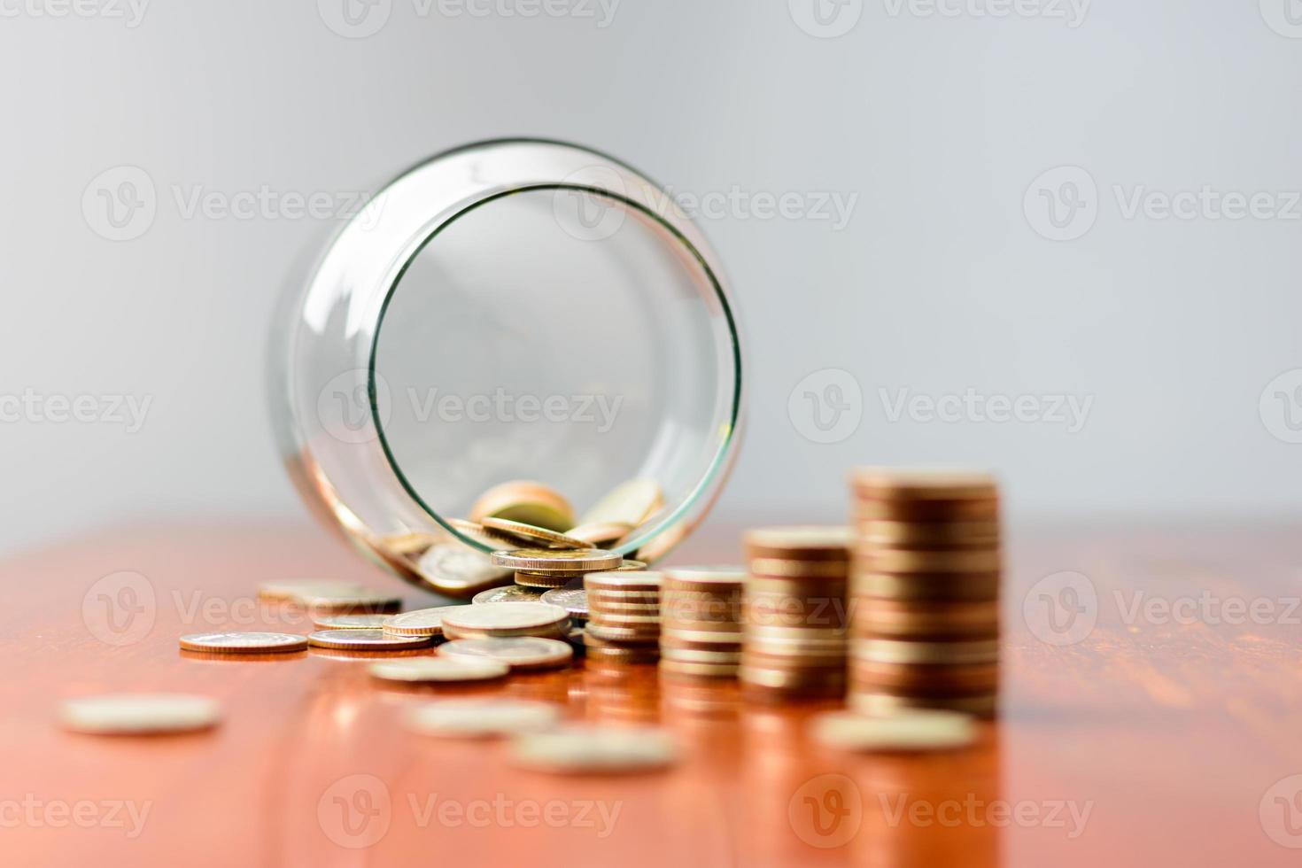 Close up Sort the coins sixth from the jar on the table. photo