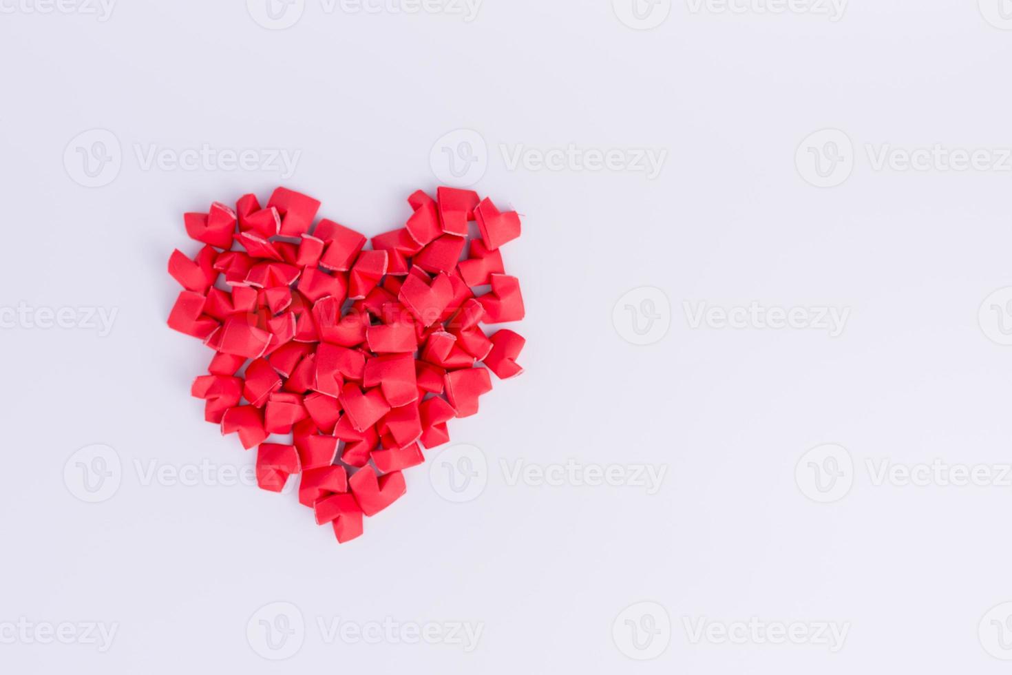 Sorting a lot of paper hearts on the table. photo