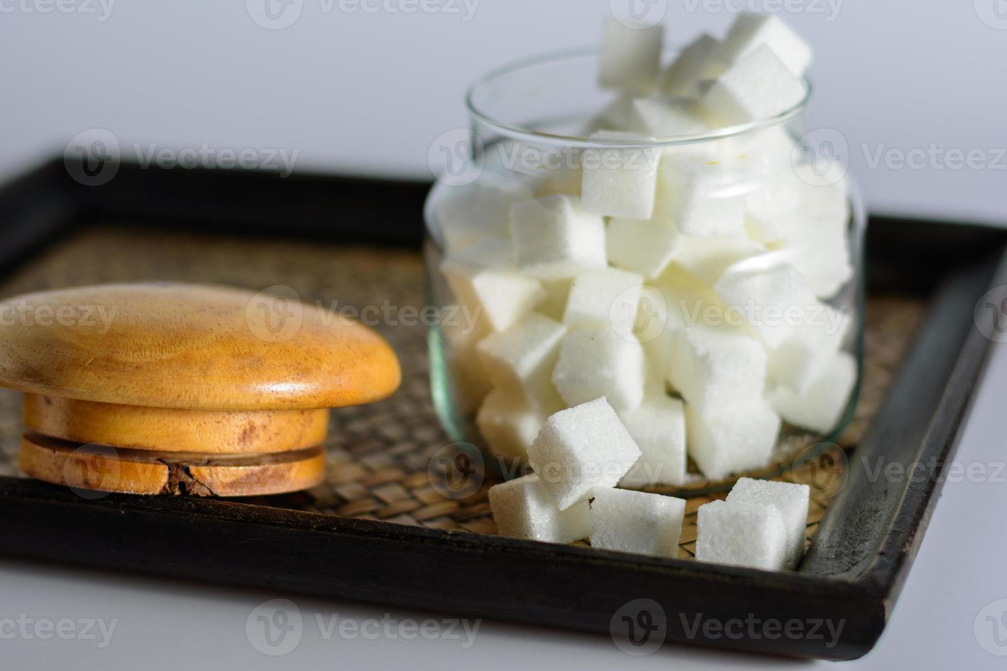 Sugar in a dozen openings on the tray. photo