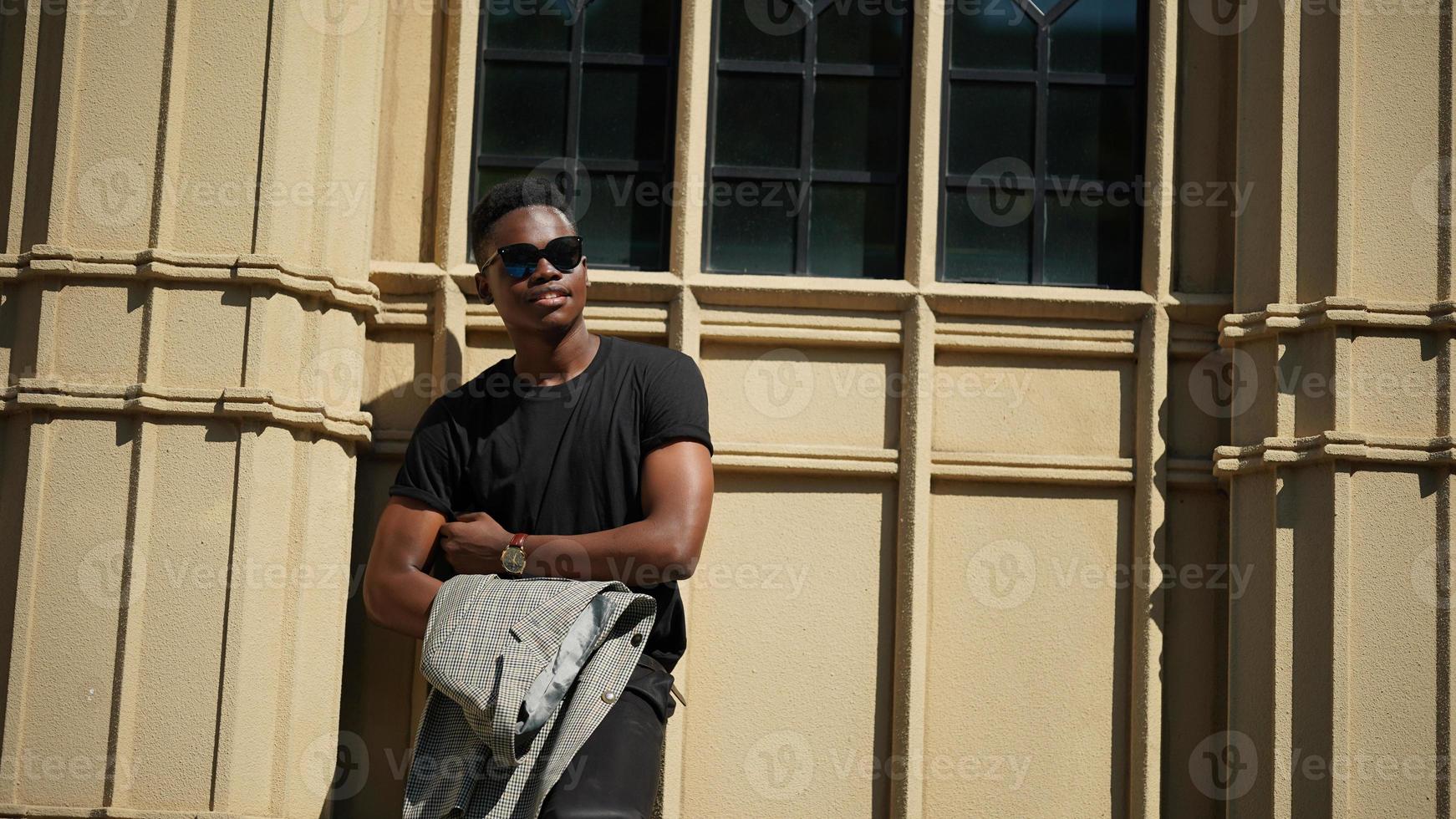 Afro American man having fun walking in city center - Happy young guy enjoying time a sunset outdoor - Millennial generation lifestyle and positive people attitude concept photo