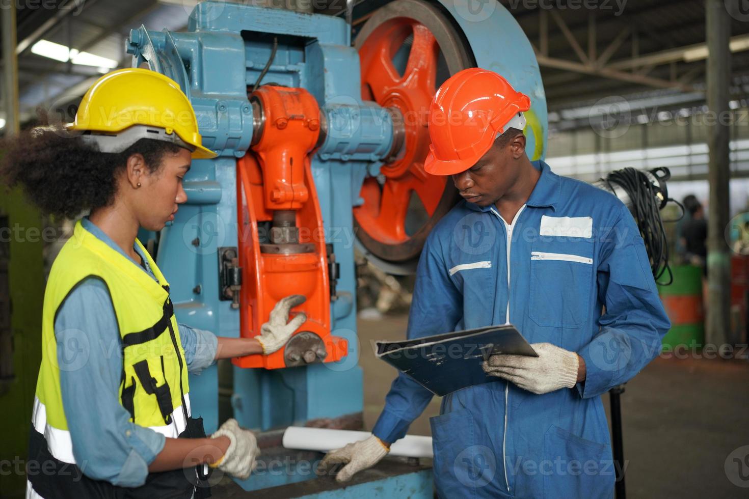Maintenance Engineers is working in front of the automated CNC machinery repair on a maintenance checklist at the production line. photo