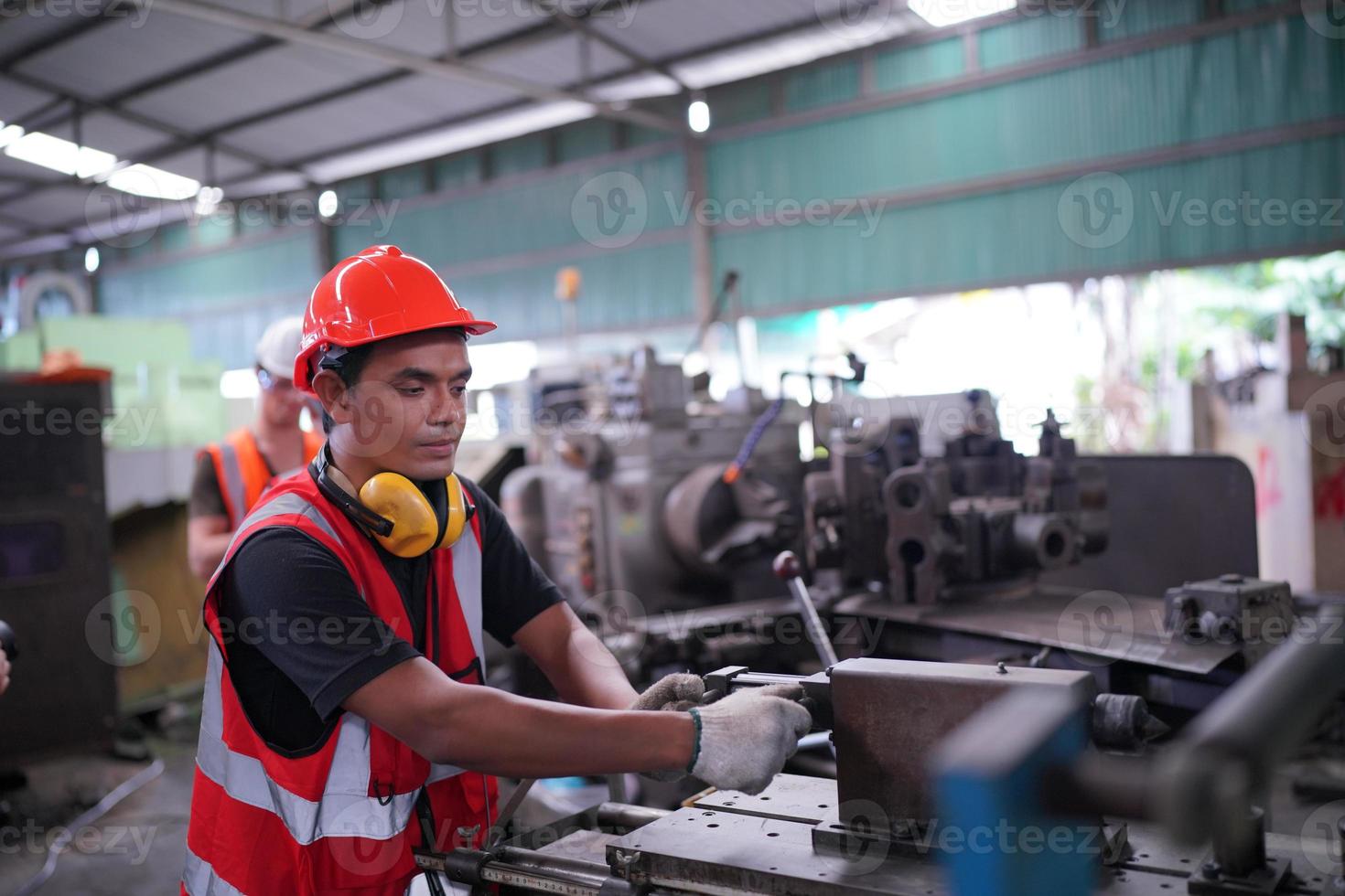 Maintenance Engineers is working in front of the automated CNC machinery repair on a maintenance checklist at the production line. photo