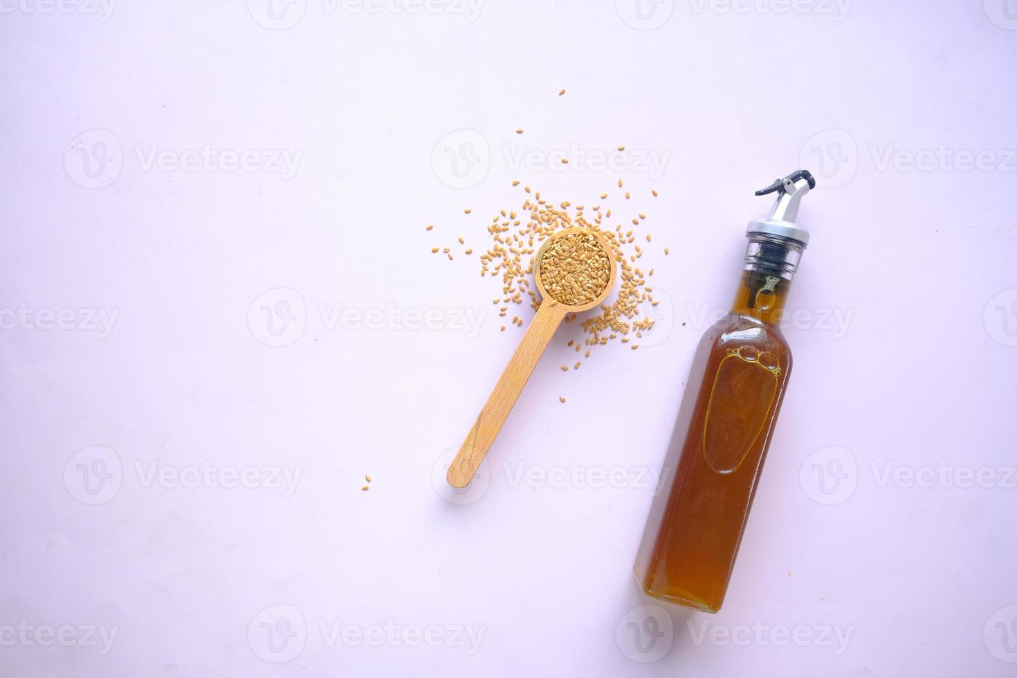 coking oil and seeds in a container on table photo