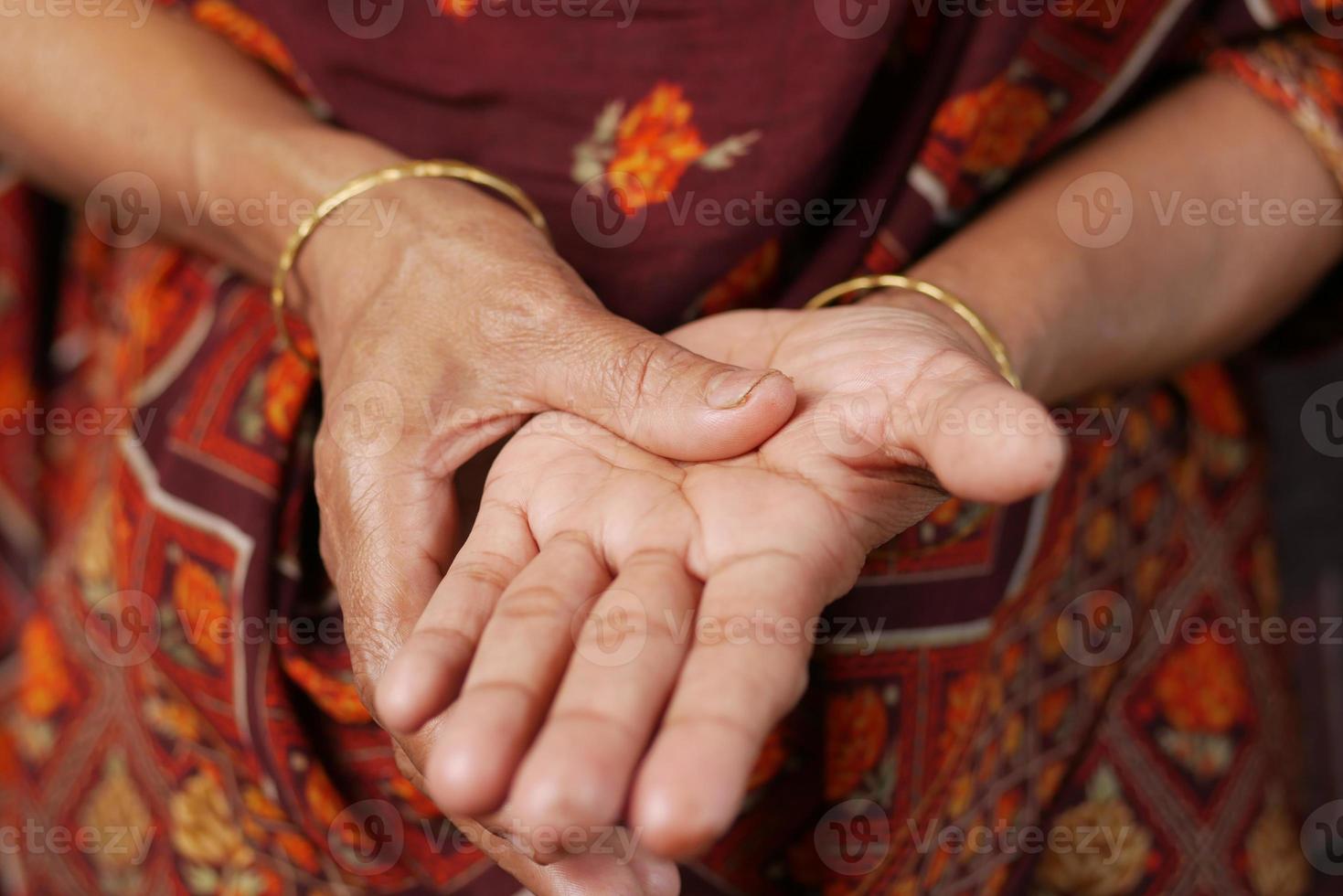 senior women suffering pain in hand close up photo